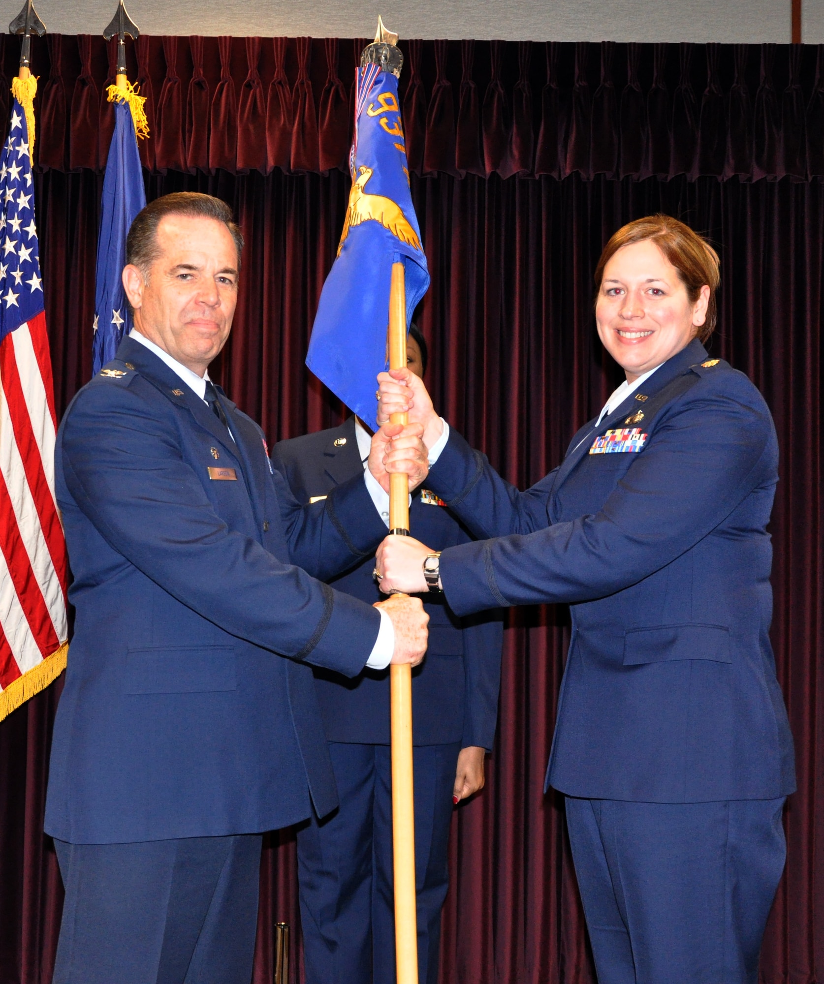 Maj. Amy White accepts the 931st Force Support Flight guidon from Col. Mark S. Larson, 931st Air Refueling Group commander.  White assumed command of the 931 FSF during a change of command ceremony conducted at McConnell Air Force Base, Kan., March 7, 2015.  White replaces outgoing commander, Lt. Col. Kerry Lehman, who had served as the 931 FSF commander for the last nine years.  (U.S. Air Force photo by Capt. Zach Anderson)  