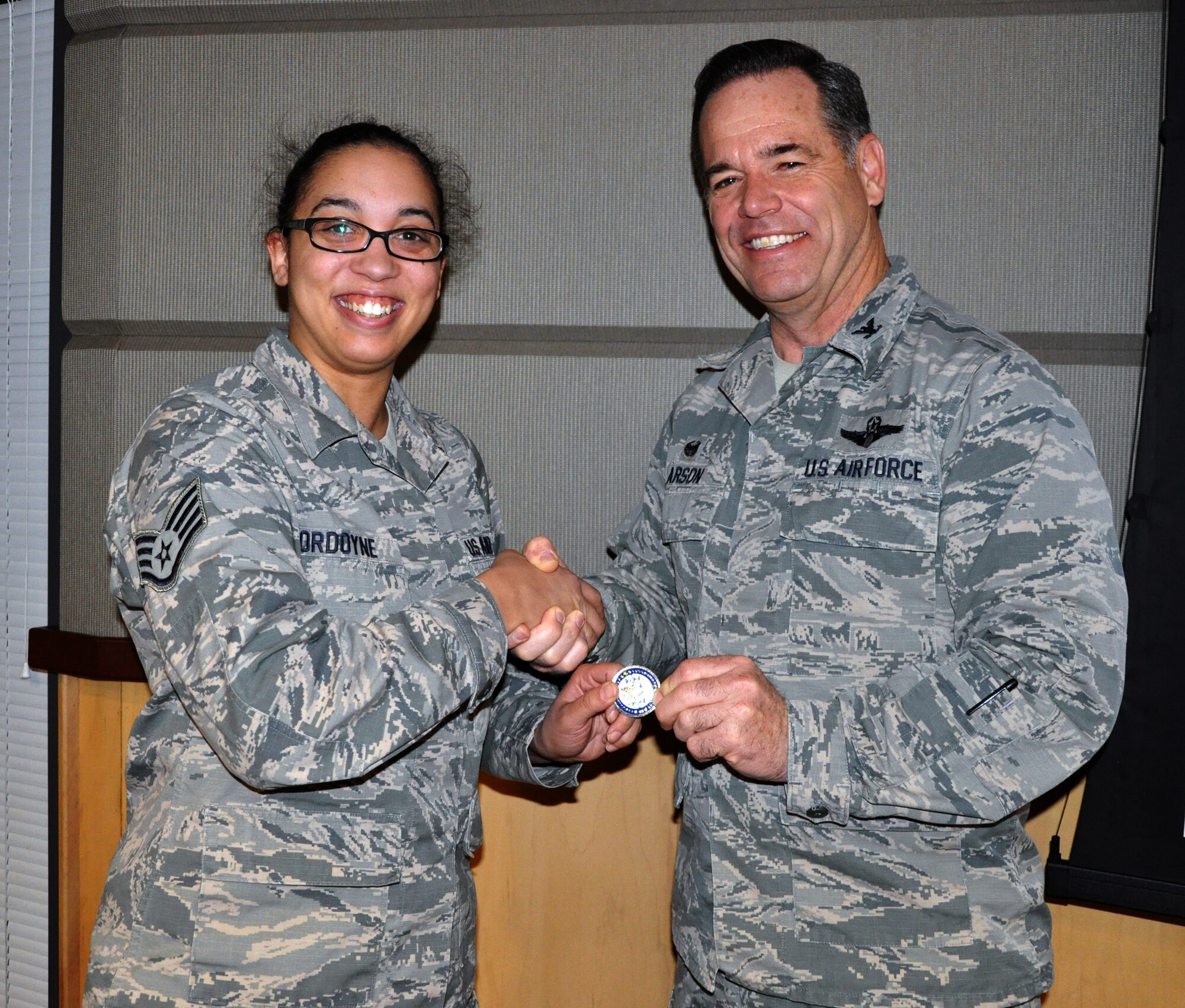 Col. Mark S. Larson, 931st Air Refueling Group commander, presents a Commander's Coin to Staff Sgt. Angelique Ordoyne, 931st Force Support Flight, during the March Unit Training Assembly, March 7, 2015.  Ordoyne runs the 931 ARG Newcomer's Program, and also has worked during the last year to manage the 931 ARG DD214 backlog. In that time, she has single-handedly processed almost 2,000 DD214s, drastically cutting down on the unit's backlog.  (U.S. Air Force photo by Capt. Zach Anderson)
