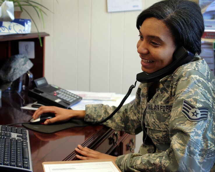 Staff Sgt. Sharia Stewart who serves as a 111th Attack Wing personnelist, Horsham Air Guard Station, Pennsylvania, multi-tasks while working in the wing commander's office during the unit training assembly March 7, 2015. The 111th AW is celebrating Women’s History Month by recognizing some of its own members throughout the month. (U.S. Air National Guard photo by Tech. Sgt. Andria Allmond/Released)
