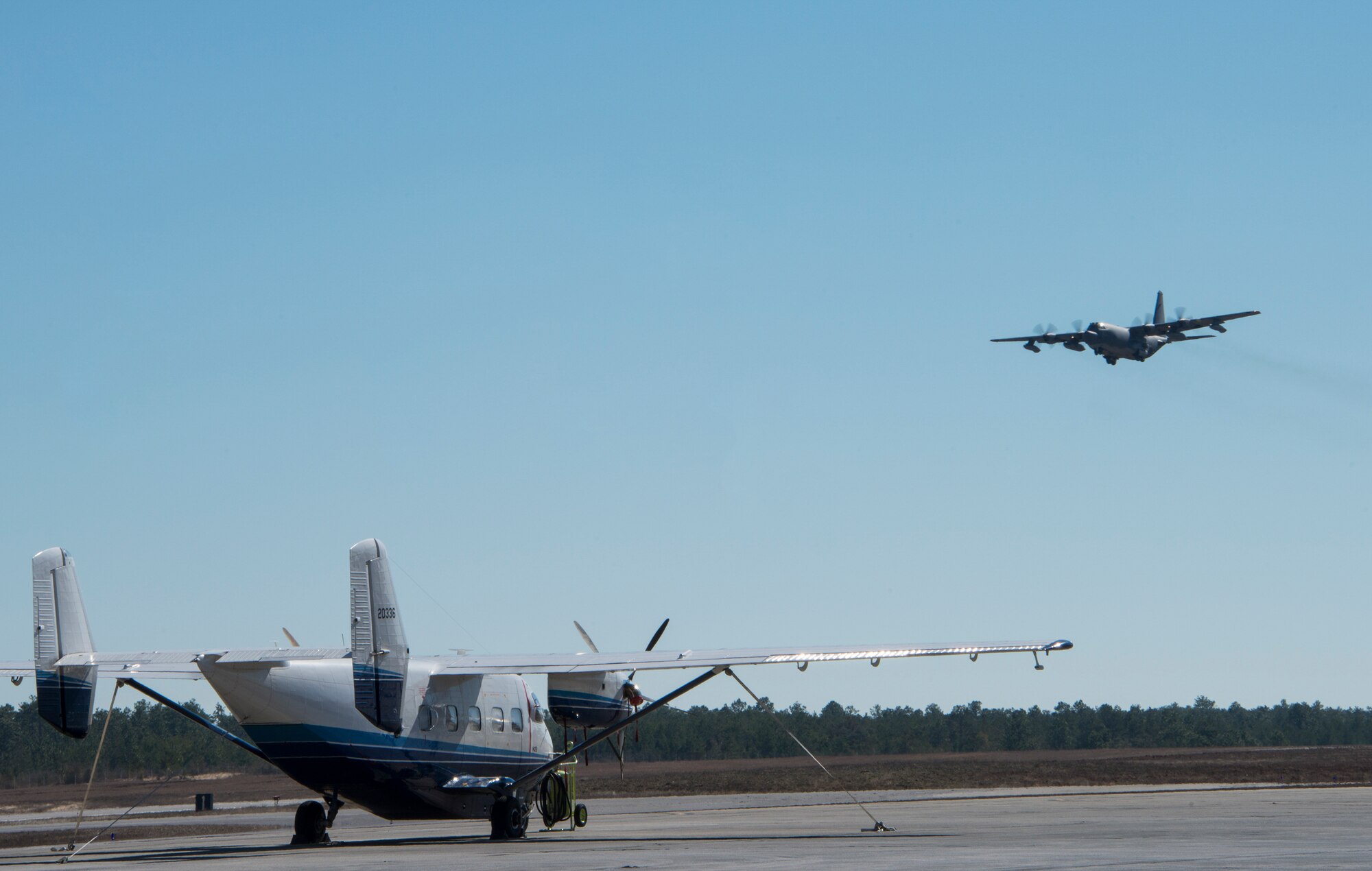 A C-145 Skytruck from the 919th Special Operations Wing waits for its next mission while a C-130 is doing some pattern work over Duke Field’s flightline Jan. 28. The Air Force Special Operations Command-owned C-145 Skytruck is now the primary aircraft on the 919th Special Operations Wing flightline at Duke Field. The aircraft is used in Aviation Foreign Internal Defense training, part of the special operations wing's mission. (U.S. Air Force photo/Tech. Sgt. Jasmin Taylor)