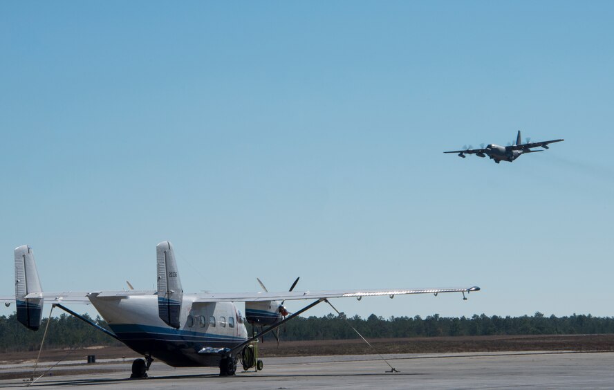A C-145 Skytruck from the 919th Special Operations Wing waits for its next mission while a C-130 is doing some pattern work over Duke Field’s flightline Jan. 28. The Air Force Special Operations Command-owned C-145 Skytruck is now the primary aircraft on the 919th Special Operations Wing flightline at Duke Field. The aircraft is used in Aviation Foreign Internal Defense training, part of the special operations wing's mission. (U.S. Air Force photo/Tech. Sgt. Jasmin Taylor)