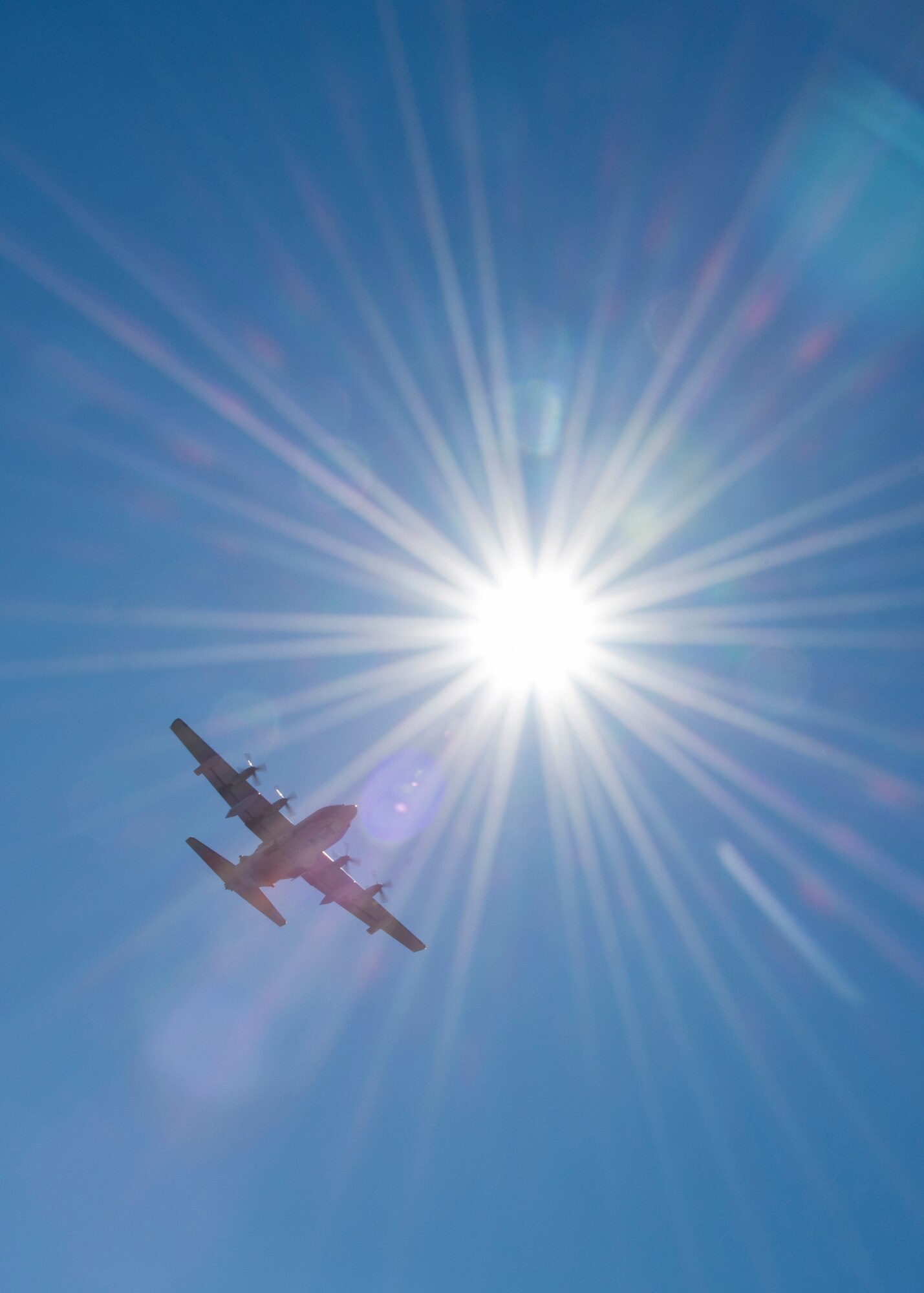 A C-130 soars by the sun while doing some pattern work over Duke Field’s flightline Jan. 28.  (U.S. Air Force photo/Tech. Sgt. Jasmin Taylor)