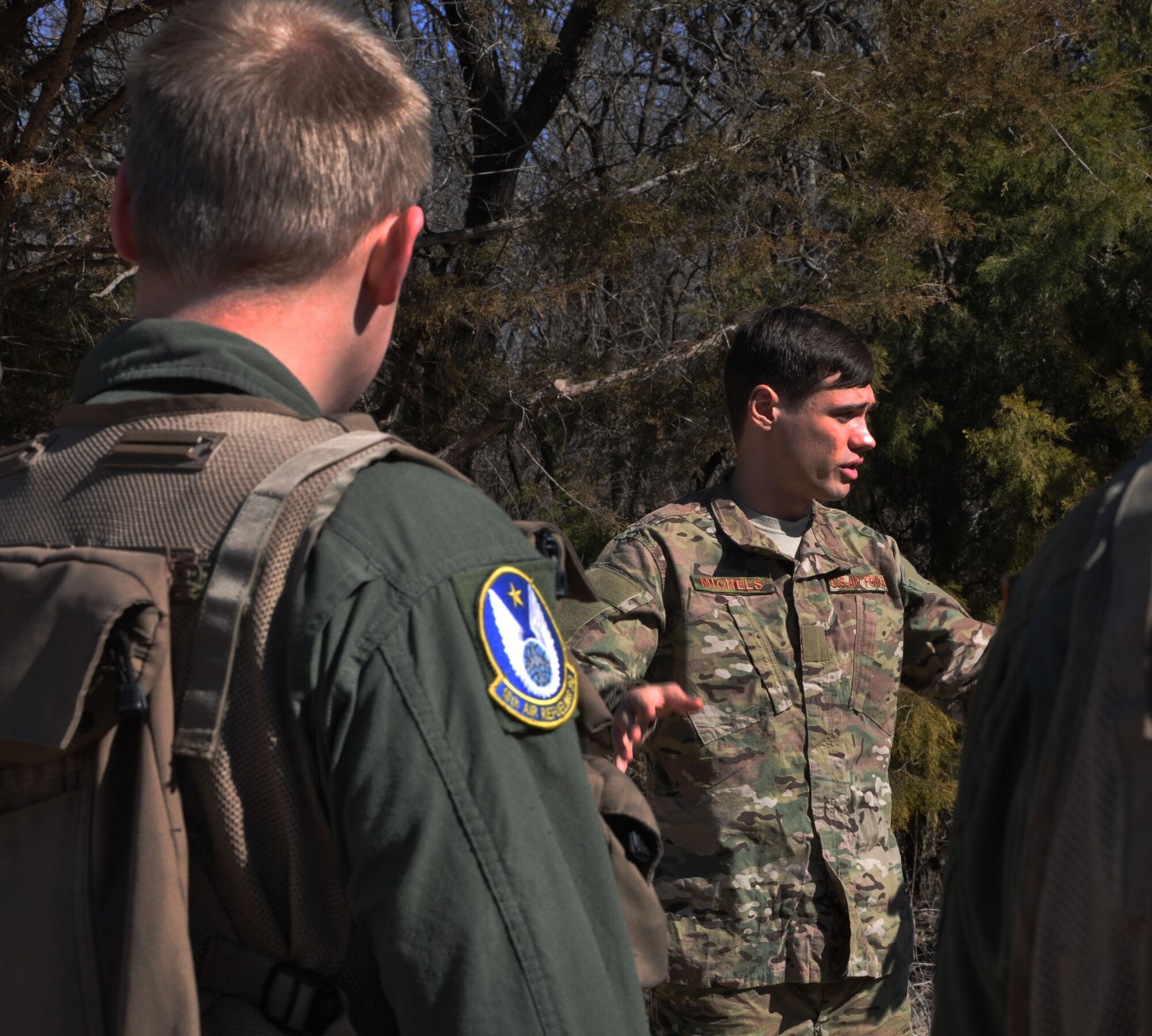 Staff Sgt. John Michels, 22nd Operations Support Squadron Survival, Evasion, Resistance, Escape instructor, briefs a group of 15 McConnell Reservists before they perform SERE training in a wooded area in Derby, Kan., March 7, 2015.  The SERE training was a refresher for the aircrew, as all Air Force aircrew go through an initial SERE training course at Fairchild AFB, Wash., during introductory training.  (U.S. Air Force photo by Tech. Sgt. Abigail Klein)