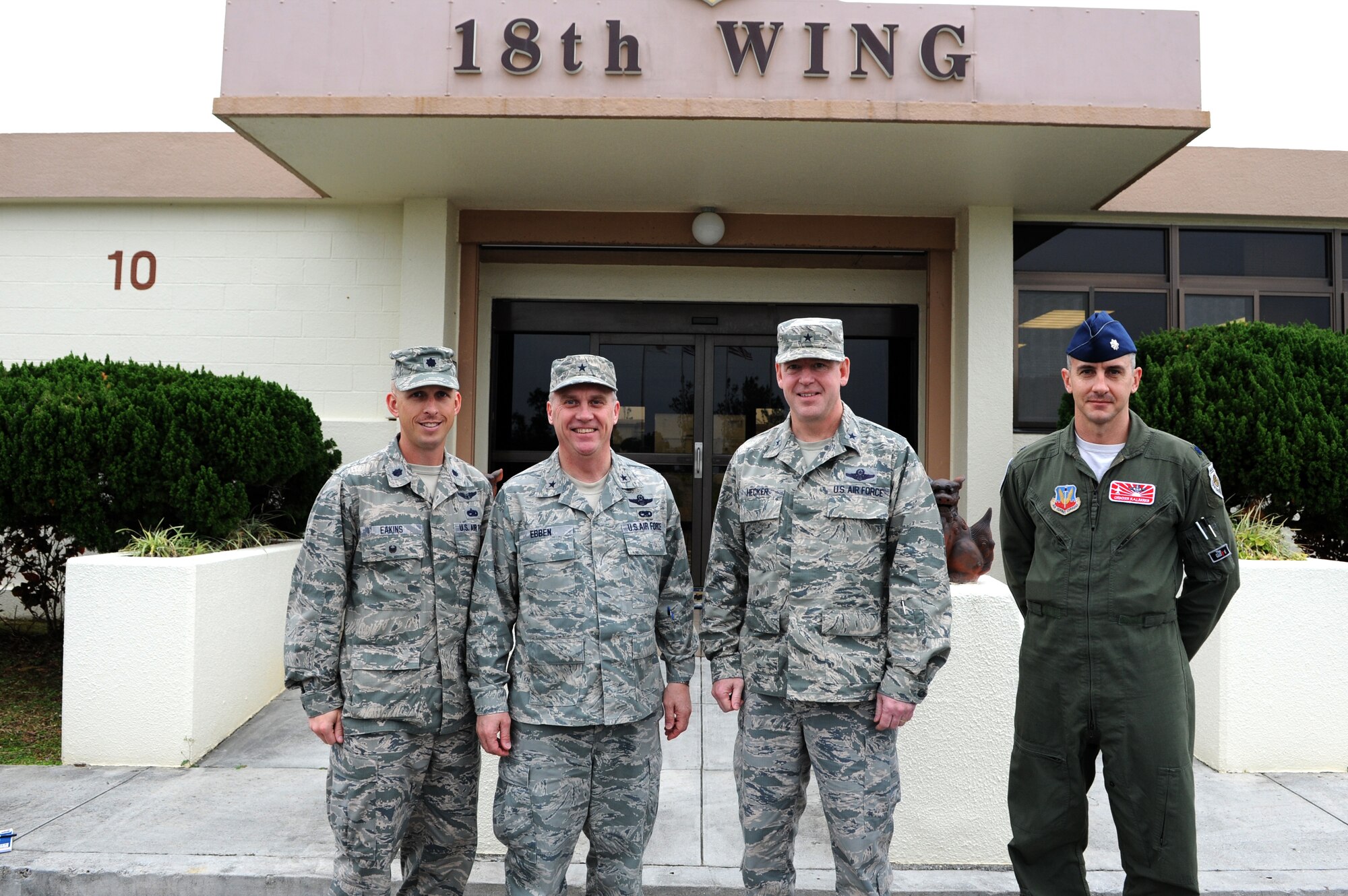 From left to right, U.S. Air Force Lt. Col. Matt Eakins, 176th Fighter Squadron maintenance officer in charge, Brig. Gen. Gary Ebben, Wisconsin National Guard assistant adjutant general, Brig. Gen. James B. Hecker, 18th Wing, commander, and Lt. Col. Jon Kalberer, 176th FS commander,  pose for a photo in front of the wing building on Kadena Air Base, Japan, March 4, 2015. Ebben was here to see how the Wisconsin Air National Guard deployment to Kadena is being completed. (U.S. Air Force photo by Airman 1st Class Stephen G. Eigel)