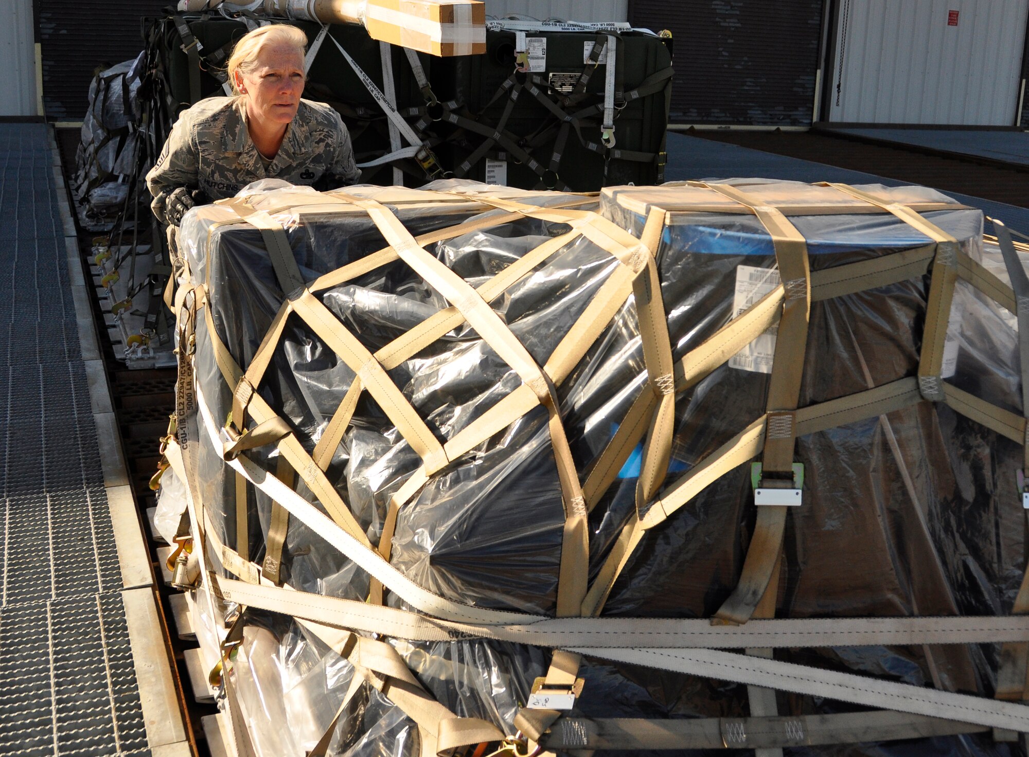 Senior Master Sgt. Wendy Hutchins, 86th Aerial Port Squadron port manager, shoves a pallet March 7, 2015, on the flightline.