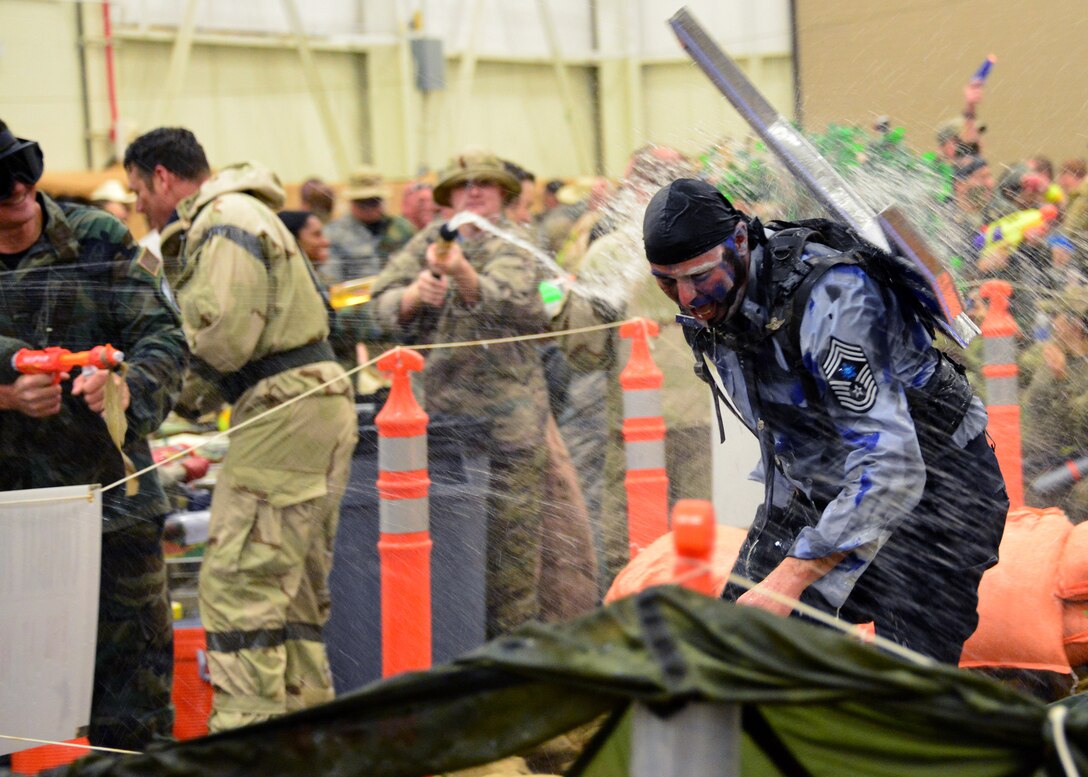 Chief Master Sgt. Thomas Mason, 919th Special Operations Wing command chief, endures water attacks from wing Airmen while going through the obstacle course at the Combat Dining-In Feb. 7 at Duke Field, Fla.  The event, the first in nine years, drew more than 250 Airmen.  A Combat Dining-In is built around the format of a traditional Dining-In, but there is less formality and combat uniforms are required. (U.S. Air Force photo/Tech. Sgt. Cheryl L. Foster)