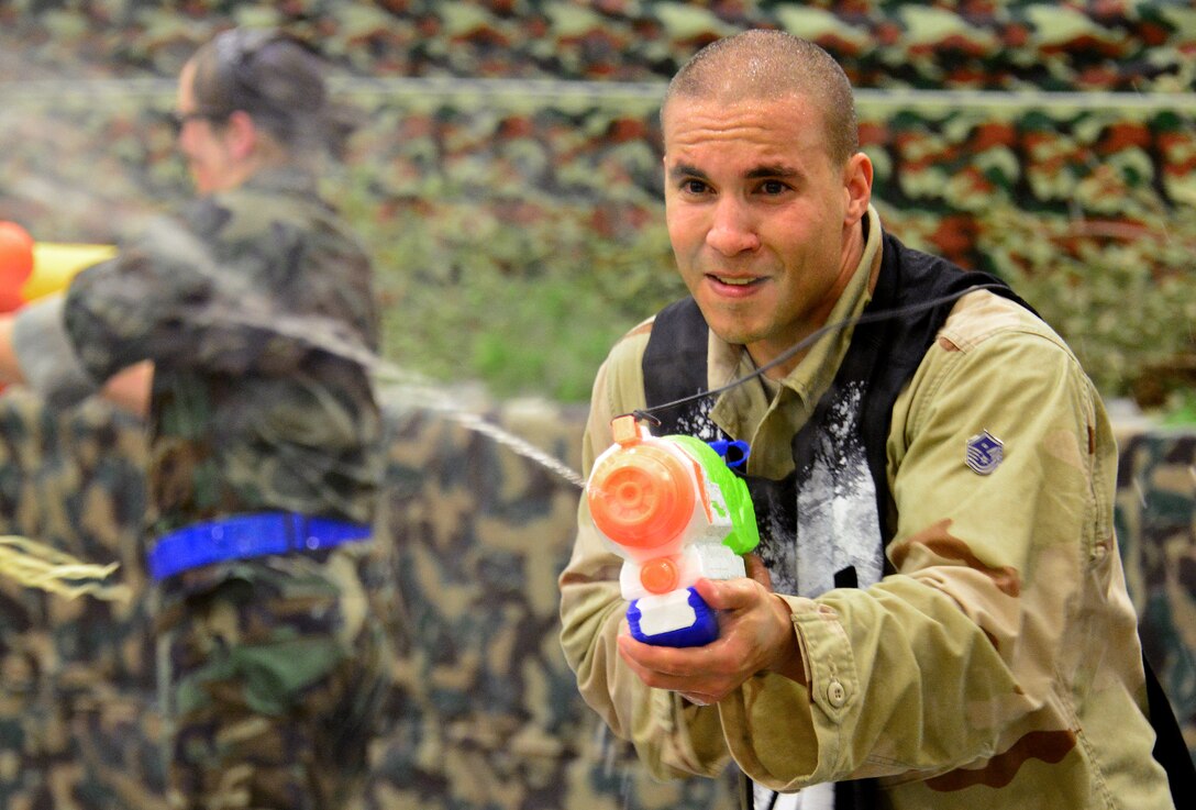Master Sgt. Thomas Richardson, 919th Special Operations Medical Squadron, shoots water at other participants at the Combat Dining-In Feb. 7 at Duke Field, Fla.  The event, the first in nine years, drew more than 250 Airmen.  A Combat Dining-In is built around the format of a traditional Dining-In, but there is less formality and combat uniforms are required. (U.S. Air Force photo/Tech. Sgt. Cheryl L. Foster)