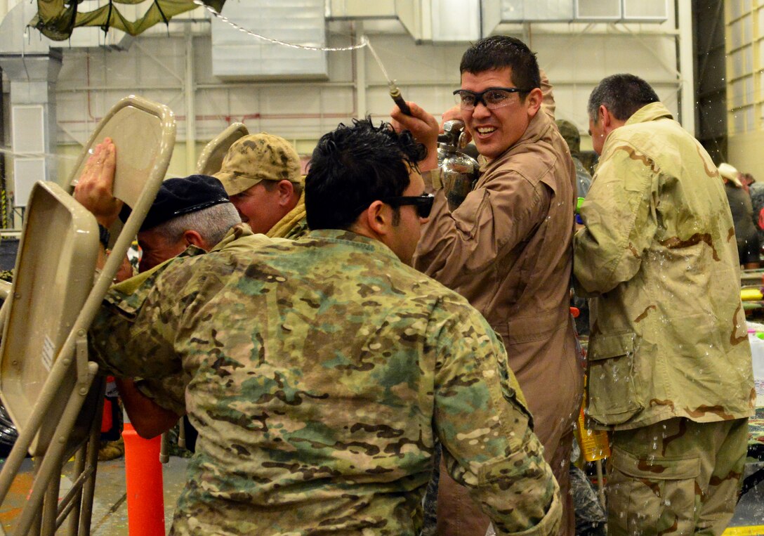 Members of the 919th Special Operations Security Forces Squadron use folding chairs to block incoming water attacks at the Combat Dining-In Feb. 7 at Duke Field, Fla.  The event, the first in nine years, drew more than 250 Airmen.  A Combat Dining-In is built around the format of a traditional Dining-In, but there is less formality and combat uniforms are required. (U.S. Air Force photo/Tech. Sgt. Cheryl L. Foster)