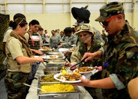 Members of the 919th Special Operations Wing fill their plates at the Combat Dining-In Feb. 7 at Duke Field, Fla.  The event, the first in nine years, drew more than 250 Airmen.  A Combat Dining-In is built around the format of a traditional Dining-In, but there is less formality and combat uniforms are required. (U.S. Air Force photo/Tech. Sgt. Cheryl L. Foster)