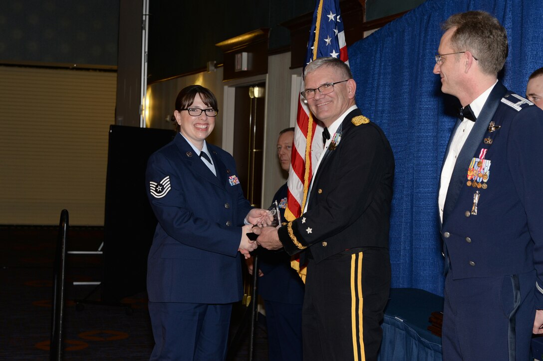 Tech. Sgt. Wendi Gunderson, left, accepts the North Dakota Air National Guard unit career advisor of the year award from Maj. Gen. David Sprynczynatyk, the North Dakota adjutant general, at the annual Outstanding Airman of the Year banquet at the Courtyard by Marriott, Moorhead, Minn., March 7, 2015. (U.S. Air National Guard photo by Senior Master Sgt. David H. Lipp/Released)