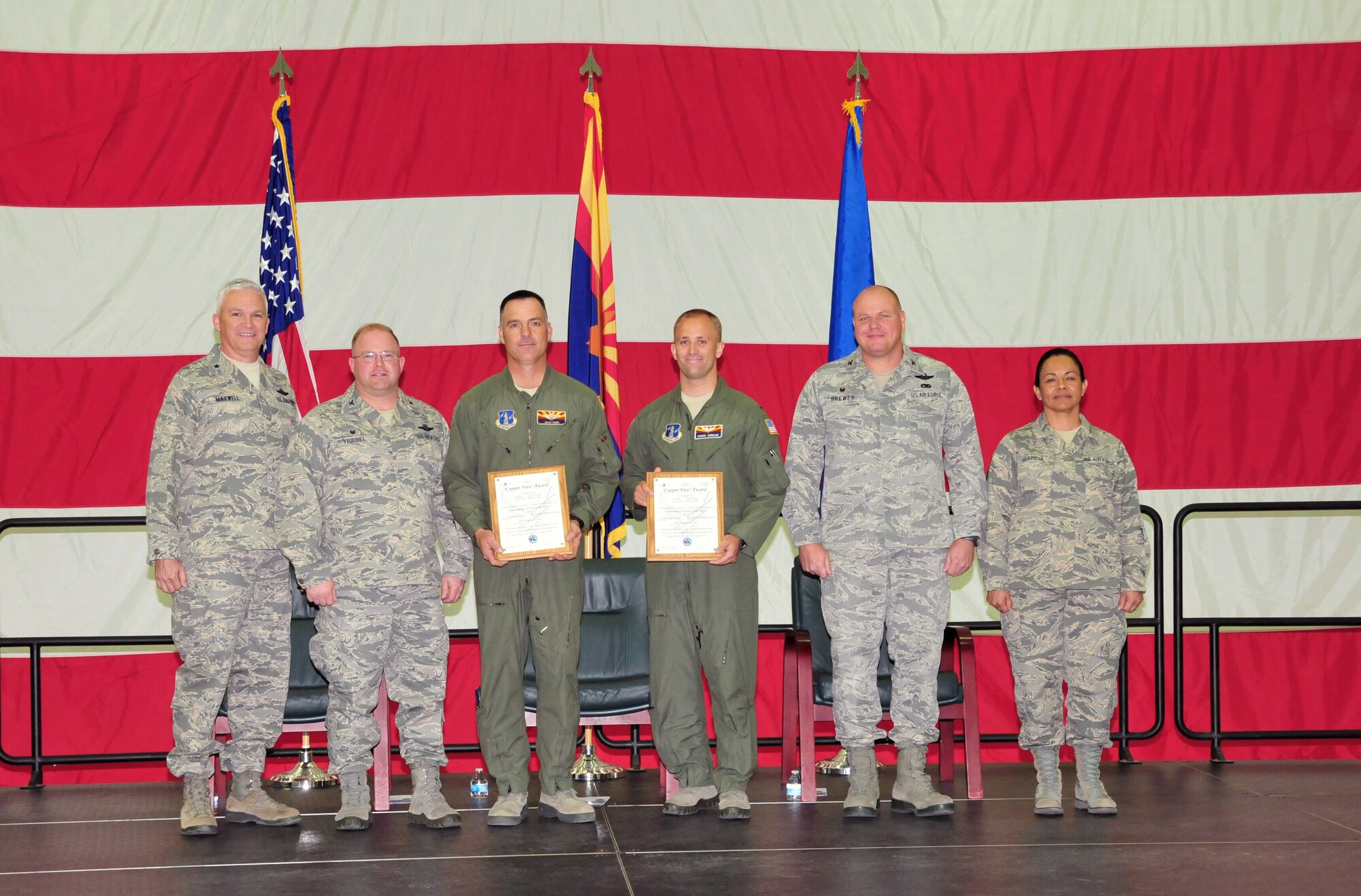 The 161st Air Refueling Wing, Phoenix Air National Guard Base, held its annual awards ceremony March 8.  The Copper Five award is presented to aircrew members who have best represented the professional skills and leadership demonstrated by the crew of Copper Five. From left, U.S. Air Force Brig. Gen. Edward Maxwell, commander of the Arizona Air National Guard; Col. Chris Triebel, 161st Operations Group commander; Lt. Col. Dean Owen, 1st Lt. William Johnson, Col. Gary Brewer, commander of the 161st Air Refueling Wing and Chief Master Sergeant Martha Garcia, 161st Air Refueling Wing command chief. (U. S. Air National Guard photo by Master Sgt. Kelly M. Deitloff)