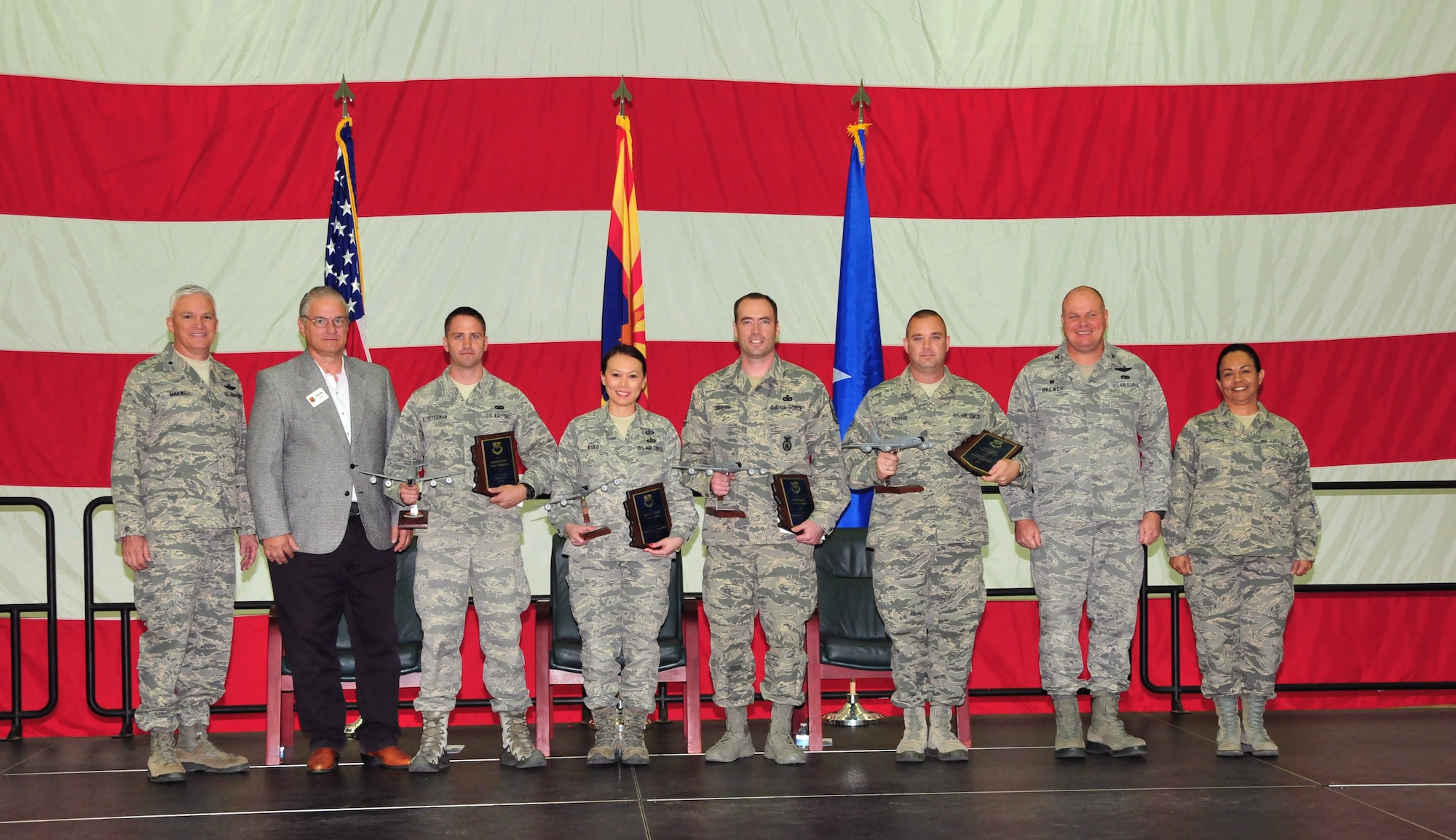 The 161st Air Refueling Wing, Phoenix Air National Guard Base, held its annual awards ceremony March 8.  The ceremony recognized the Outstanding Airmen of the year. From left, U.S. Air Force Brig. Gen. Edward Maxwell, commander of the Arizona Air National Guard; Mr. Dean Butler, president of the Phoenix Air National Guard Patriots; Senior Airman Justin Klosterman, Airman of the Year; Tech. Sgt. Cherry Rose Ayulo, junior noncommissioned officer of the year; Master Sgt. James Swanson, senior noncommissioned officer of the year; Staff Sgt. David Griffin, command chief award recipient; Colonel Gary Brewer, commander of the 161st Air Refueling Wing and Chief Master Sergeant Martha Garcia, 161st Air Refueling Wing command chief. (U. S. Air National Guard photo by Master Sgt. Kelly M. Deitloff)