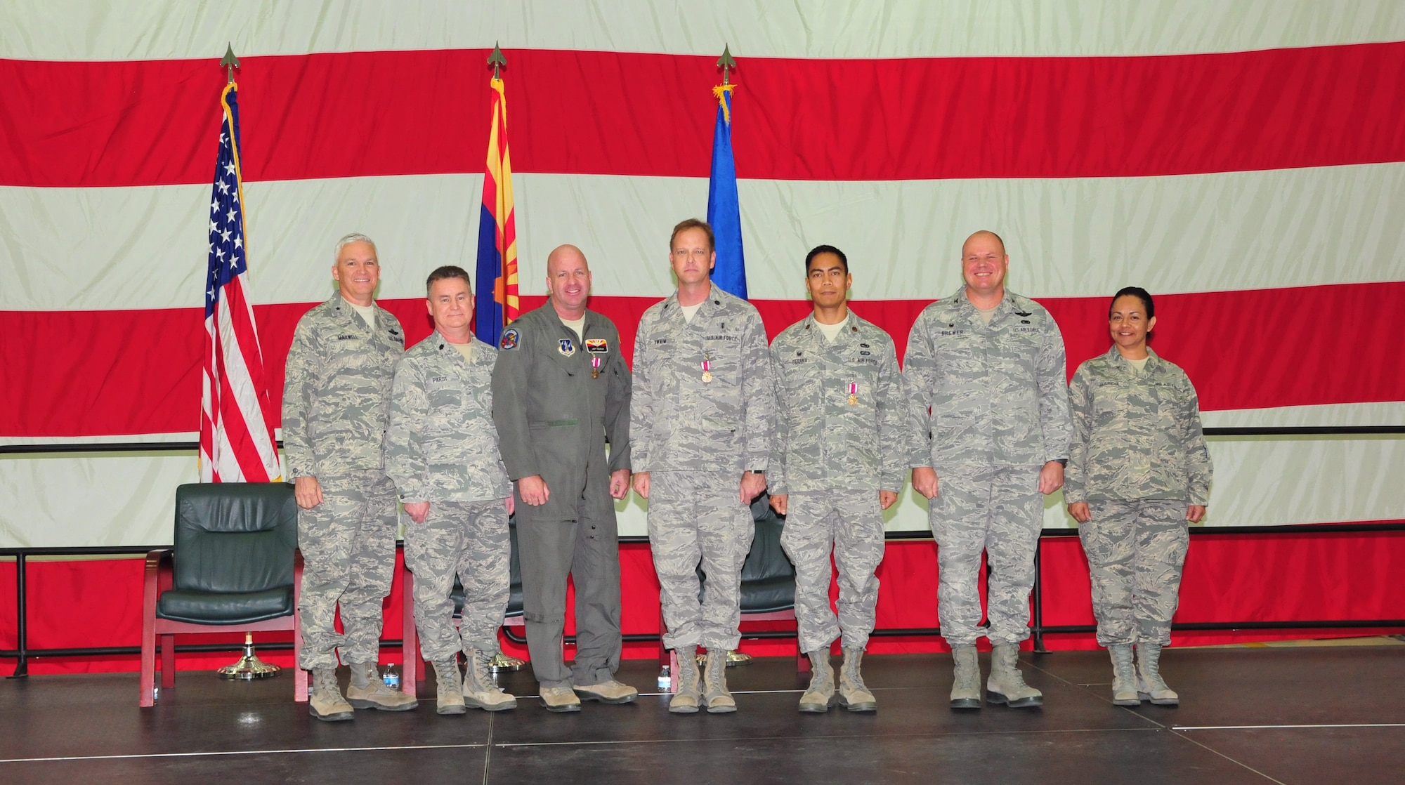 The 161st Air Refueling Wing, Phoenix Air National Guard Base, held its annual awards ceremony March 8.  The ceremony recognized members who received the federal Meritorious Service Medal.  This military decoration is awarded to the following Airmen for unique accomplishments in their particular fields, or for distinguished careers in the service of our country. From left, U.S. Air Force Brig. Gen. Edward Maxwell, commander of the Arizona Air National Guard, Lt. Col. Christopher Parot, Col. Hoyt Slocum, Lt. Col. Darcy Swaim, Maj. Gilbert Besana, Col. Gary Brewer, commander of the 161st Air Refueling Wing and Chief Master Sgt. Martha Garcia, 161st Air Refueling Wing command chief. (U. S. Air National Guard photo by Master Sgt. Kelly M. Deitloff)