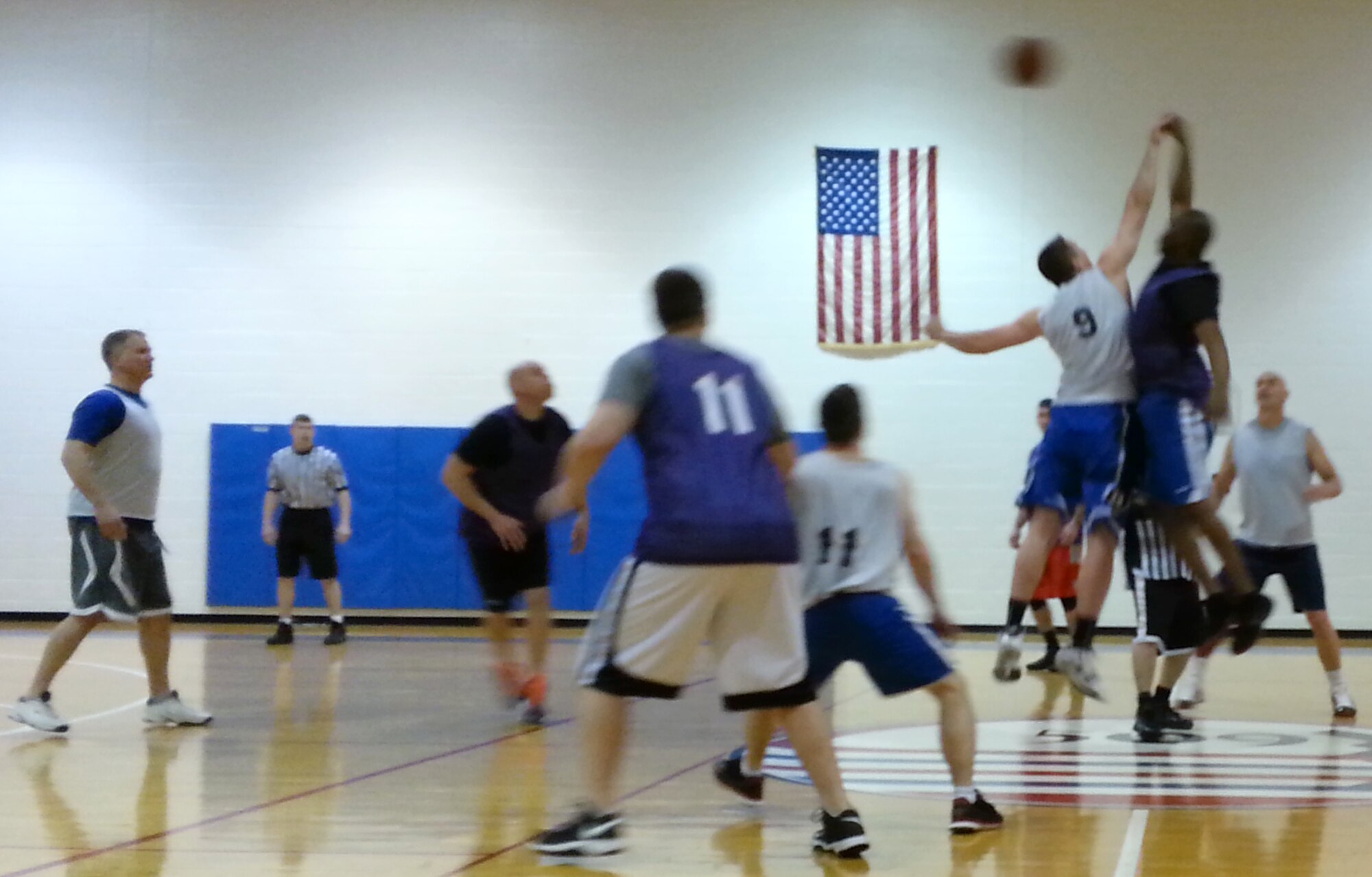 Members of the 442d Fighter Wing, in white jerseys, play against members of the 509th Operations Support Squadron, in blue jerseys, to secure the Over 30 Men's Basketball championship on January 29. The 442FW defeated the active duty by 16 points. (Photo submitted by Master Sgt. Jamil Goodwin)
