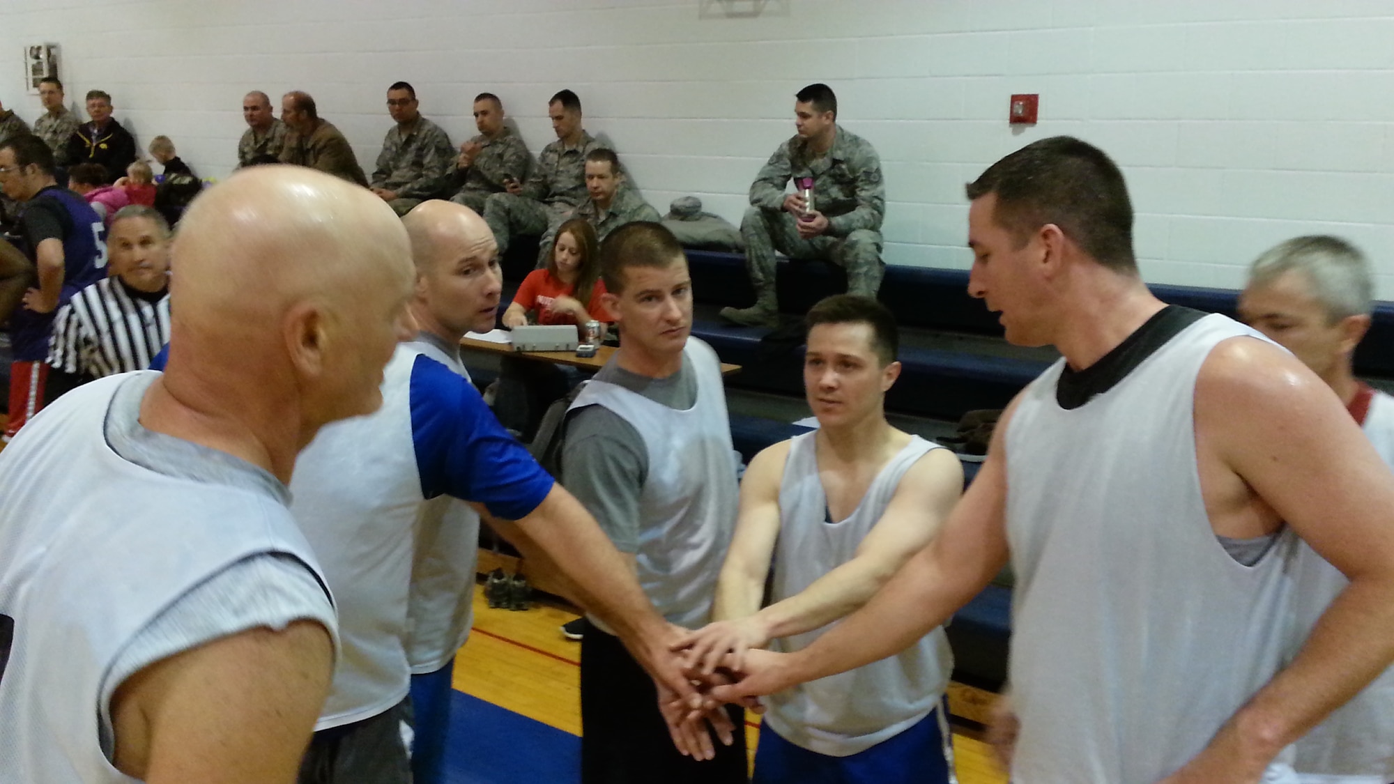 Lt. Col. Todd Riddle, center in blue shorts, coached his Over 30 Men's Basketball championship team to victory for the fifth time in seven years in the Over 30 Men's Basketball championship on January 29. Staff Sgt. Benjamin Franklin, to Riddle's left, stands six and a half feet tall. The 442FW defeated the active duty by 16 points. (Photo submitted by Master Sgt. Jamil Goodwin)
