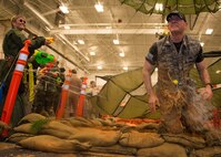 Maj. Kevin Kulz, 592nd Special Operations Maintenance Squadron, is drenched as he crawls out of the obstacle course at the Combat Dining-In Feb. 7 at Duke Field, Fla.  The event, the first in nine years, drew more than 250 Airmen.  A Combat Dining-In is built around the format of a traditional Dining-In, but there is less formality and combat uniforms are required. (U.S. Air Force photo/Tech. Sgt. Jasmin Taylor)