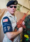 Chief Master Sgt. Ronald McCulley, 919th Special Operations Security Forces Squadron, shows off his altered uniform at the Combat Dining-In Feb. 7 at Duke Field, Fla.  The event, the first in nine years, drew more than 250 Airmen.  A Combat Dining-In is built around the format of a traditional Dining-In, but there is less formality and combat uniforms are required. (U.S. Air Force photo/Tech. Sgt. Jasmin Taylor)
