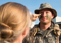 Staff Sgt. Brian Matthias, 592nd Special Operations Maintenance Squadron, receives war paint as he waits in line to enter the Combat Dining-In Feb. 7 at Duke Field, Fla.  The event, the first in nine years, drew more than 250 Airmen.  A Combat Dining-In is built around the format of a traditional Dining-In, but there is less formality and combat uniforms are required. (U.S. Air Force photo/Tech. Sgt. Jasmin Taylor)
