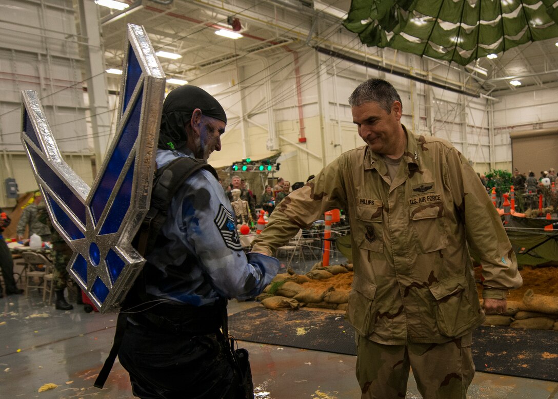 Chief Master Sgt. Thomas Mason (left) and Col. James Phillips (right), 919th Special Operations Wing command chief and commander, congratulate each other after completing the obstacle course at the Combat Dining-In Feb. 7 at Duke Field, Fla.  The event, the first in nine years, drew more than 250 Airman.  A Combat Dining-In is built around the format of a traditional Dining-In, but there is less formality and combat uniforms are required. (U.S. Air Force photo/Tech. Sgt. Jasmin Taylor)