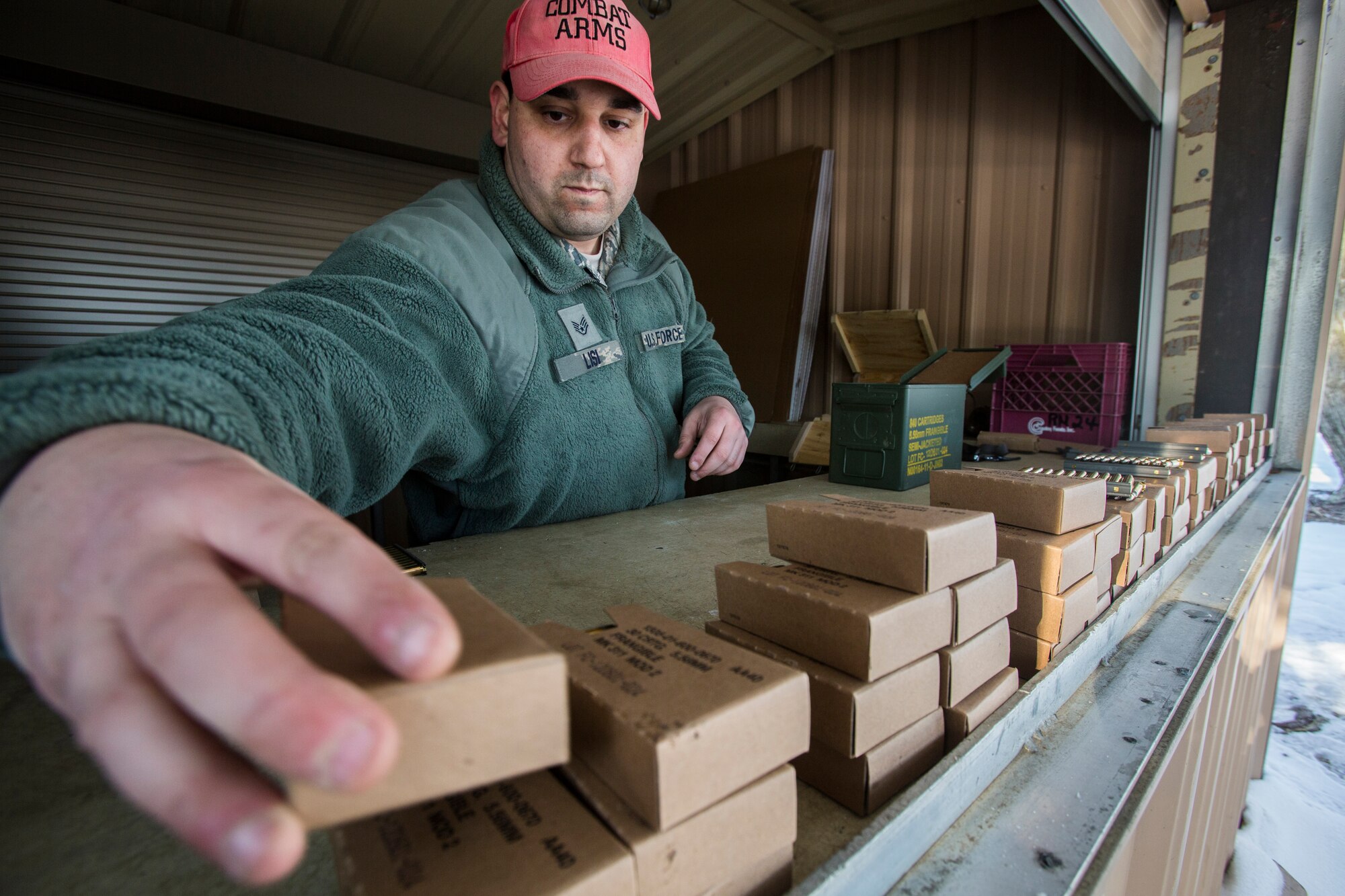 Staff Sgt. Stephen J. Lisi, Combat Arms Training and Maintenance, 108th Wing, New Jersey Air National Guard, stacks 5.56mm ammunition boxes in preparation for 108th Airmen qualifying on the M4 Carbine at Joint Base McGuire-Dix-Lakehurst, N.J., March 8, 2015. (U.S. Air National Guard photo by Master Sgt. Mark C. Olsen/Released)