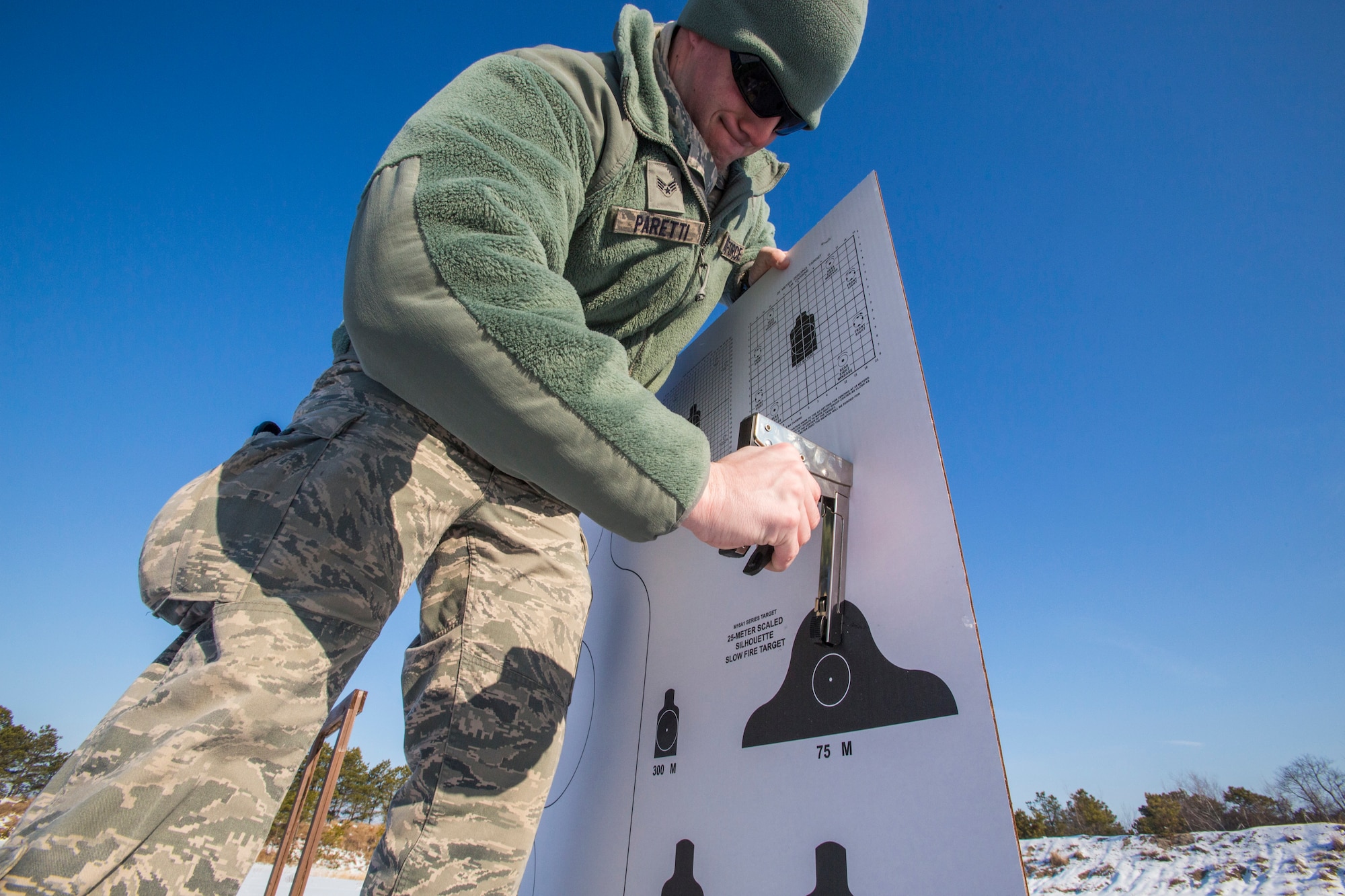 Senior Airman Joseph C. Paretti, Combat Arms Training and Maintenance, 108th Wing, New Jersey Air National Guard, attaches a target in preparation for 108th Airmen qualifying on the M4 Carbine at Joint Base McGuire-Dix-Lakehurst, N.J., March 8, 2015. (U.S. Air National Guard photo by Master Sgt. Mark C. Olsen/Released)