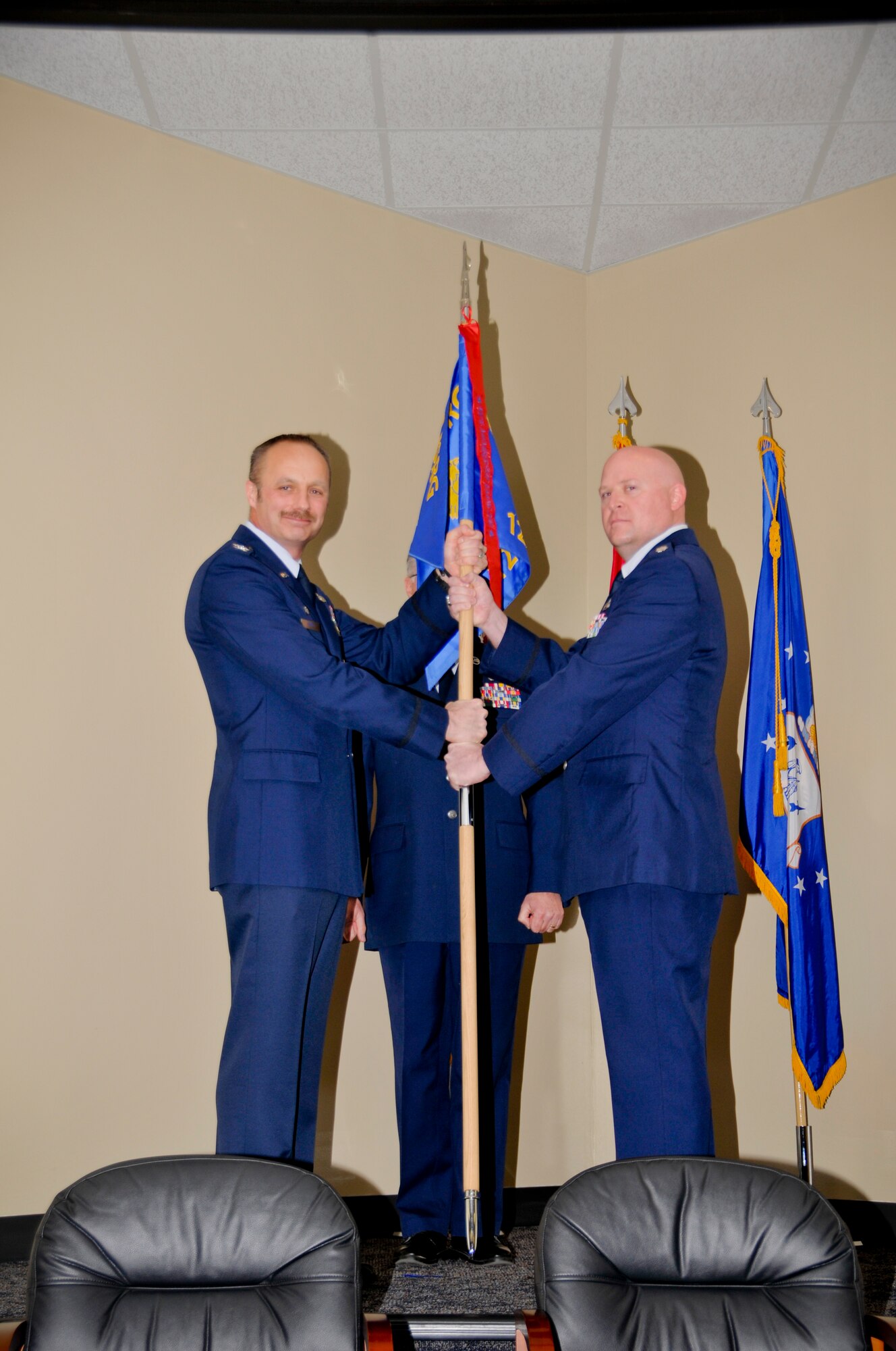 Col. Robert I. Kinney, 188th Intelligence, Surveillance and Reconnaisance Group commander, hands over the 123rd Intelligence Squadron flag to Lt. Col. Sonny L. Stefancic, 123rd IS commander, during a change of command ceremony held March 8 at Ebbing Air National Guard Base, Fort Smith, Ark. (U.S. Air National Guard photo by Staff Sgt. John Suleski)
