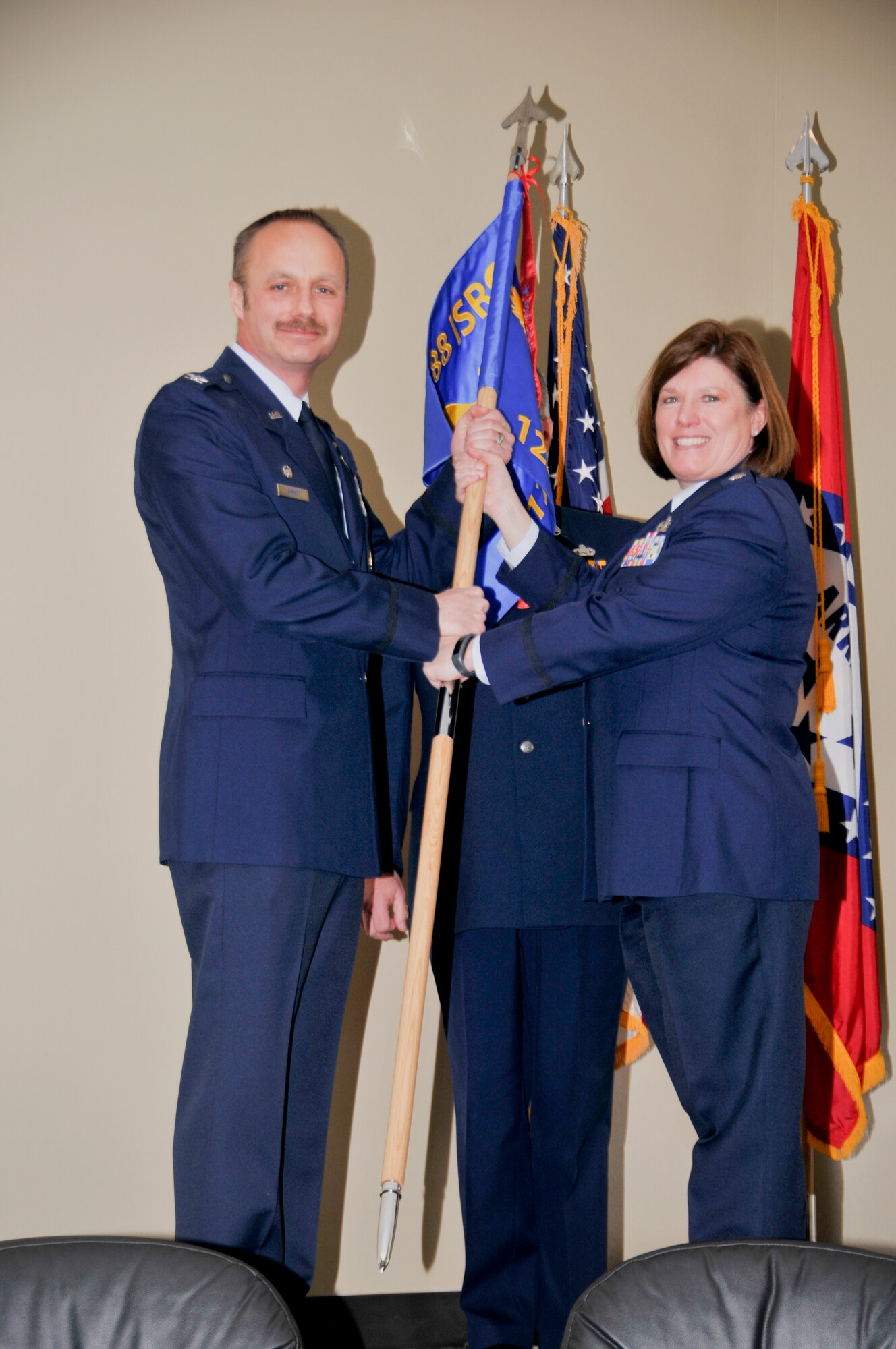 Lt. Col. Tina L. Lipscomb, former 123rd Intelligence Squadron commander, relinquishes the 123rd flag to Col. Robert I. Kinney, 188th Intelligence, Surveillance and Reconnaissance Group commander, during a change of command ceremony held March 8 at Ebbing Air National Guard Base, Fort Smith, Ark. (U.S. Air National Guard photo by Staff Sgt. John Suleski/released)