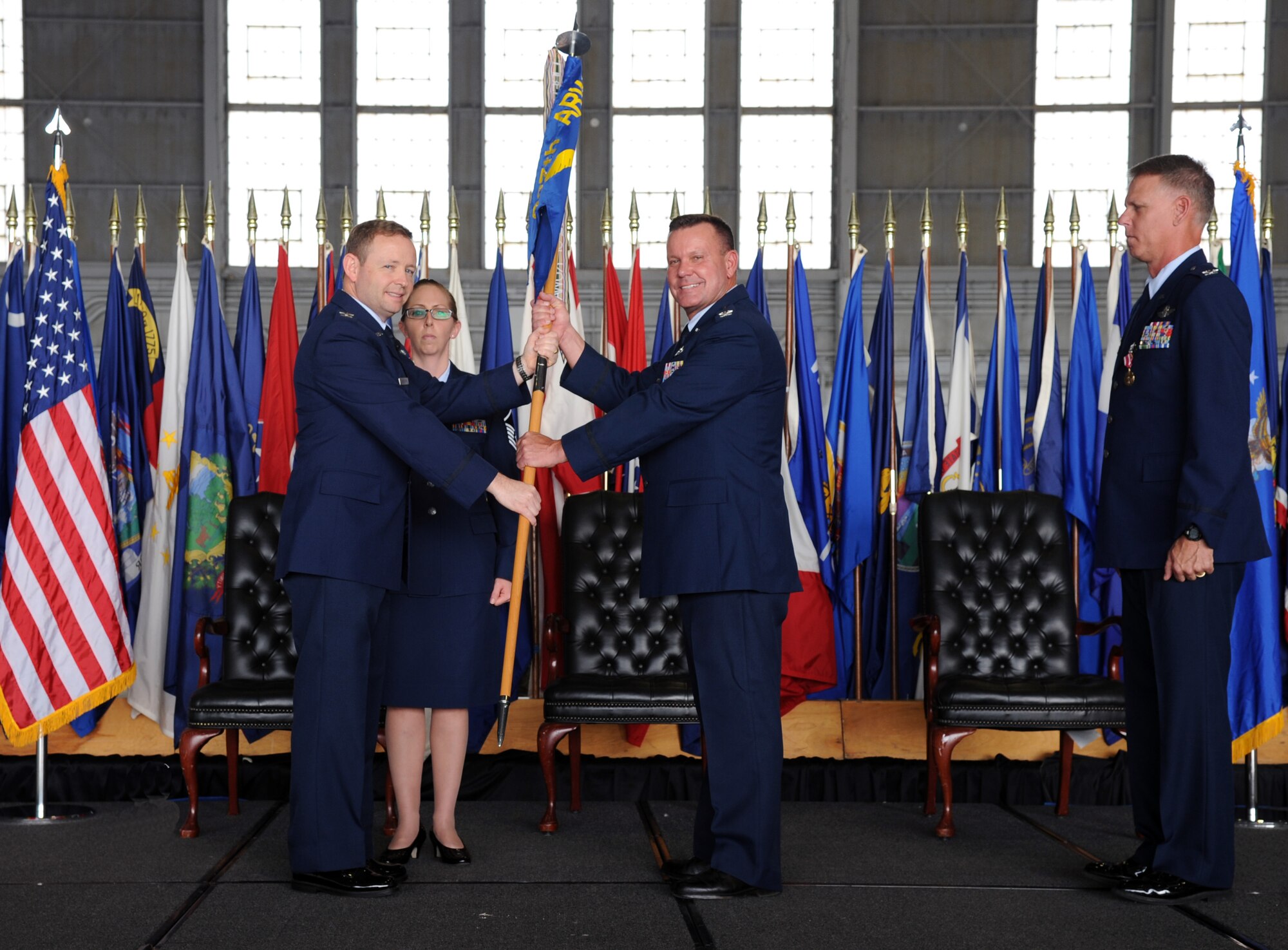 Colonel William Rolocut took command of the 927th Operations Group in a change of command ceremony held here, March 7. On left Col. Brad Anderson, 927th Air Refueling Wing vice commander passes the 927th OG guidon to Col. Rolocut. (U.S. Air Force photo/Tech. Sgt. Peter Dean)