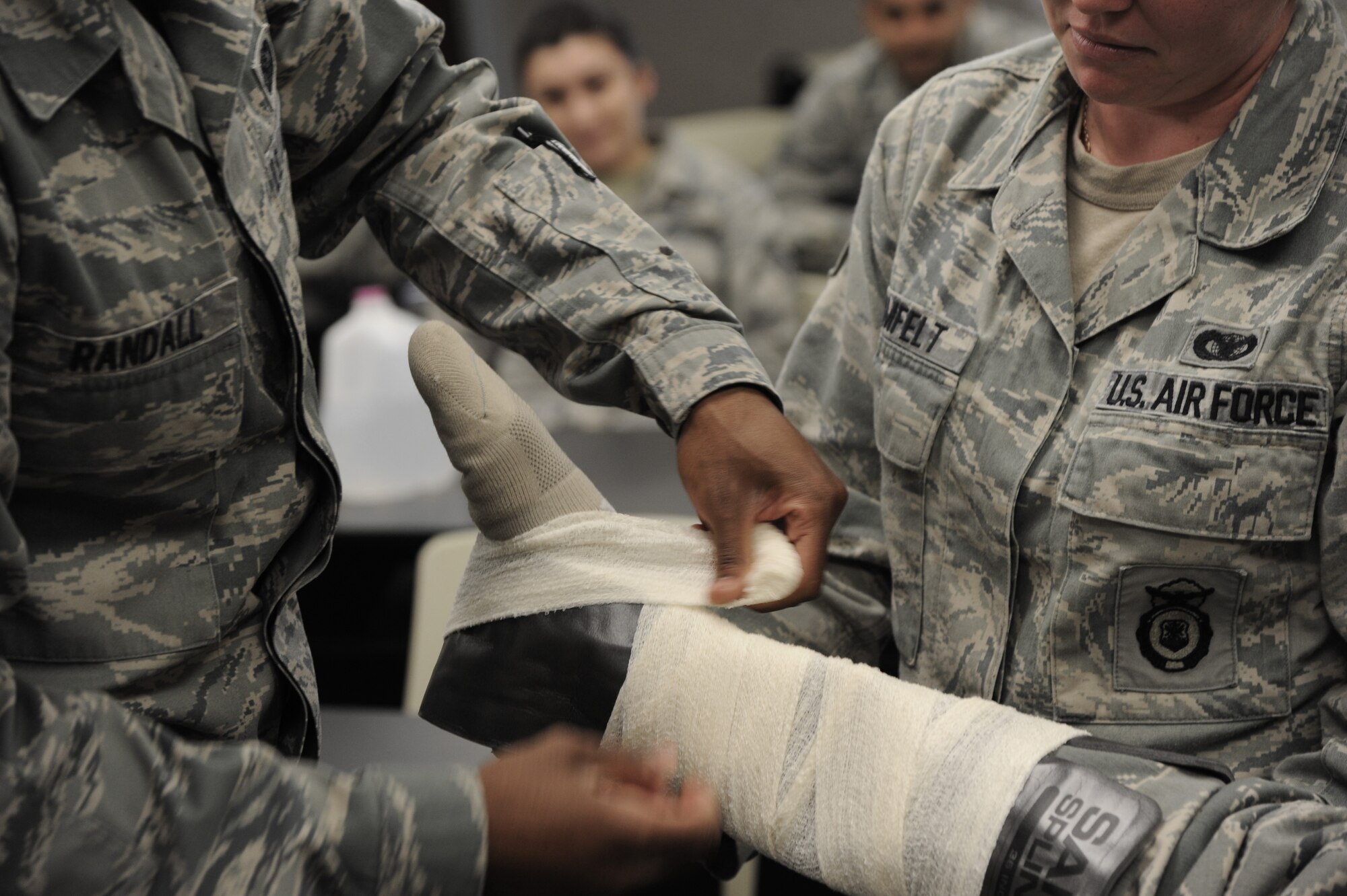 Members of the 927th Security Forces Squadron administer a  SAM splint at MacDill Air Force Base, Fla., March 8, 2015. Self-Aid and Buddy care requires the members who attend the training to learn how to properly dress wounds with the equipment provided. (U.S. Air Force photo/Senior Airman Xavier Lockley)