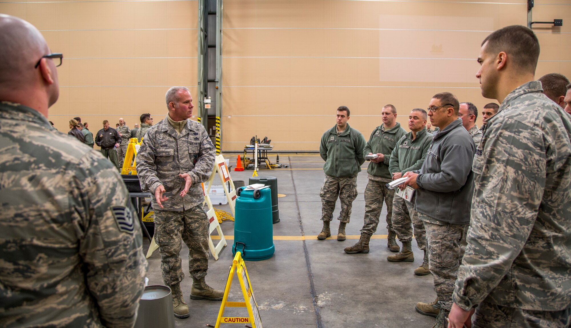 Master Sgt. Timothy Moore, 102nd Intelligence Wing emergency manager, demonstrates how to transition between contaminated zones during an expeditionary skills rodeo March 6, 2015 at Otis Air National Guard Base, Mass. Approximately 350 Airmen from the 102nd IW participated in hands-on training which covered self-aid buddy care and chemical, biological, radiological and nuclear defense. (Air National Guard photo by Staff Sgt. Jeremy Bowcock)