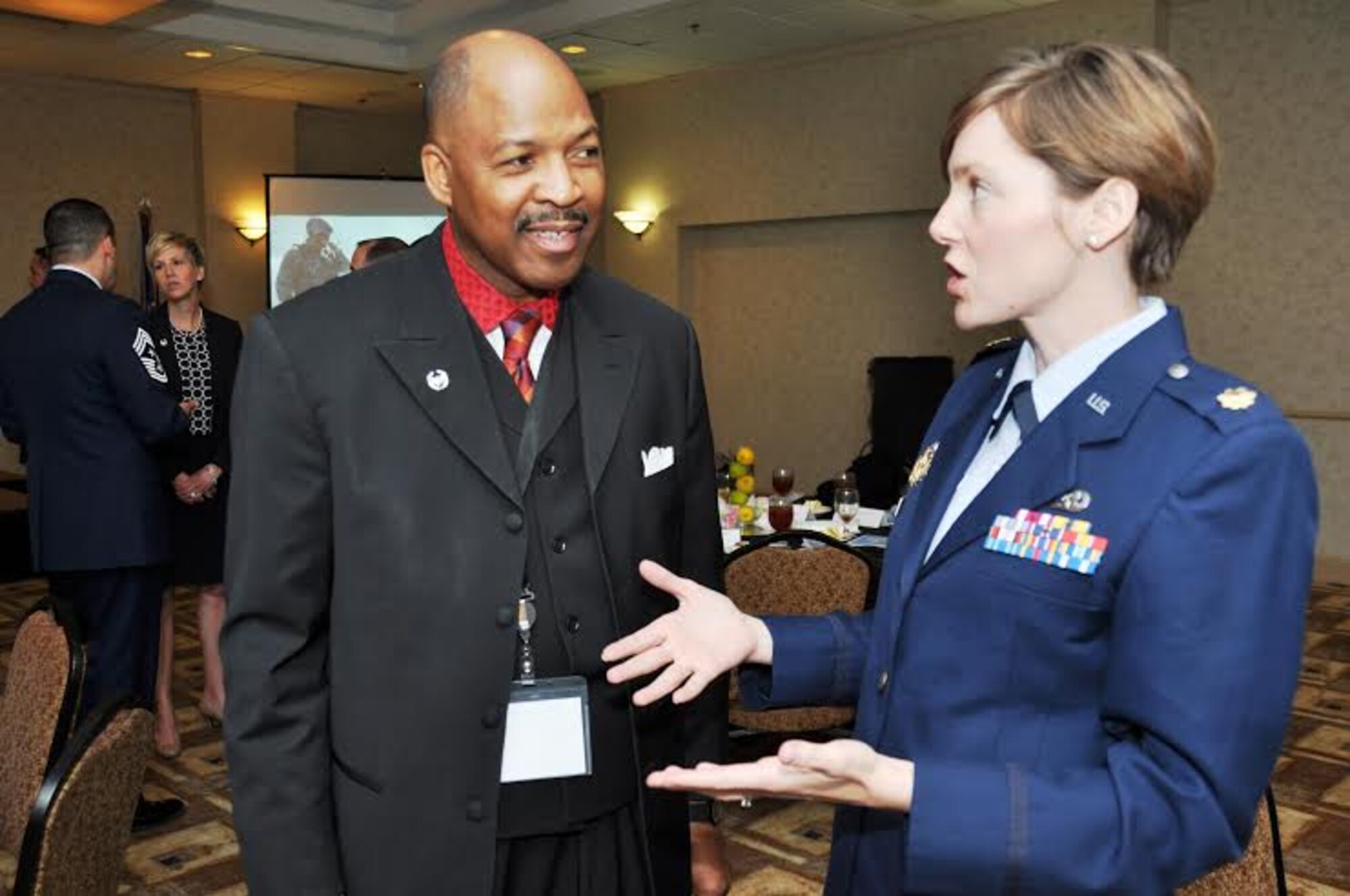 Rev. Michael Jolla, Honorary Commander for the 26th Aerial Port Squadron, talks with Maj. Allison Meghann, after the fourth annual Alamo Wing Honorary Commanders Induction ceremony March 7, 2015 at the Double Tree Hotel in San Antonio, Texas. The 433rd Airlift Wing inducted 14 business and community leaders into the 2015 Honorary Commanders Program in which local business leaders and executives are paired with commanders and senior leadership in the "Alamo Wing" to educate them about the activities of the 433rd AW, the Air Force Reserve and its vital role in national defense. (U.S. Air Force Photo by Tech. Sgt. Carlos J. Trevino)
