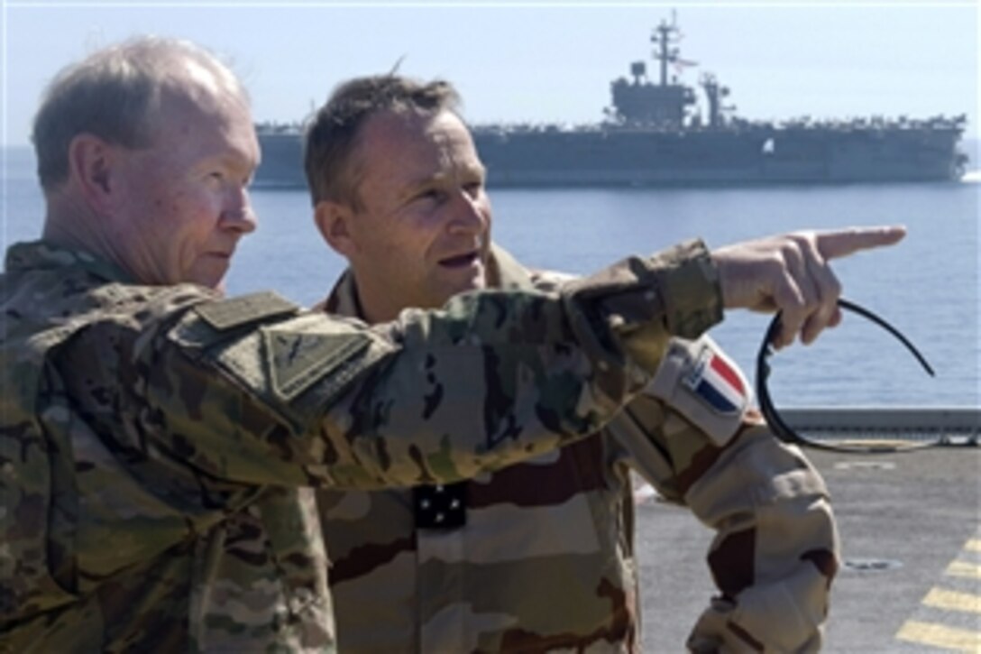 U.S. Army Gen. Martin E. Dempsey, chairman of the Joint Chiefs of Staff, and his French counterpart, Gen. Pierre de Villiers, share thoughts aboard the French aircraft carrier Charles de Gaulle in the Persian Gulf, March 8, 2015.