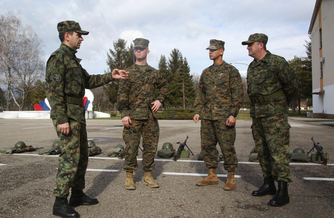 Commander of the Serbian Armed Force Training Center Pancevo, Maj. Sasha Petkovic, speaks with U.S. Marine Corps 2nd Lt. Caleb Clubb and Staff Sgt. Jonathan Sidhu, U.S. Marines with Black Sea Rotational Force supporting the NCO workshop in Serbia, on the first day of the military-to-military engagement.  Serbian Armed Forces service members worked with U.S. Marines to share information about the noncommissioned officer rank at the Serbian Armed Forces Training Center Pancevo, March 3-6, 2015. This engagement allowed for a greater understanding in Serbia’s effort in working toward NATO interoperability in the area of leader development. (U.S. Marine Corps photo by 1st Lt. Sarah E. Burns)