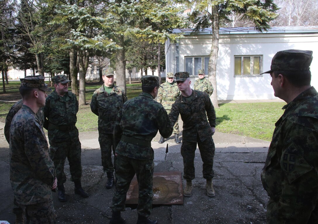 Commander of the Serbian Armed Force Training Center Pancevo, Maj. Sasha Petkovic, shakes hands with U.S. Marine Corps 2nd Lt. Caleb Clubb, a U.S. Marine with Black Sea Rotational Force supporting the NCO workshop in Serbia, upon concluding the NCO Workshop at the Serbian Armed Forces Training Center Pancevo, March 3-6, 2015. Serbian Armed Forces service members worked with four U.S. Marines to share information about the noncommissioned officer rank and role and responsibilities of a platoon sergeant. This engagement allowed for a greater understanding in Serbia’s effort in working toward NATO interoperability in the area of leader development. (U.S. Marine Corps photo by 1st Lt. Sarah E. Burns)