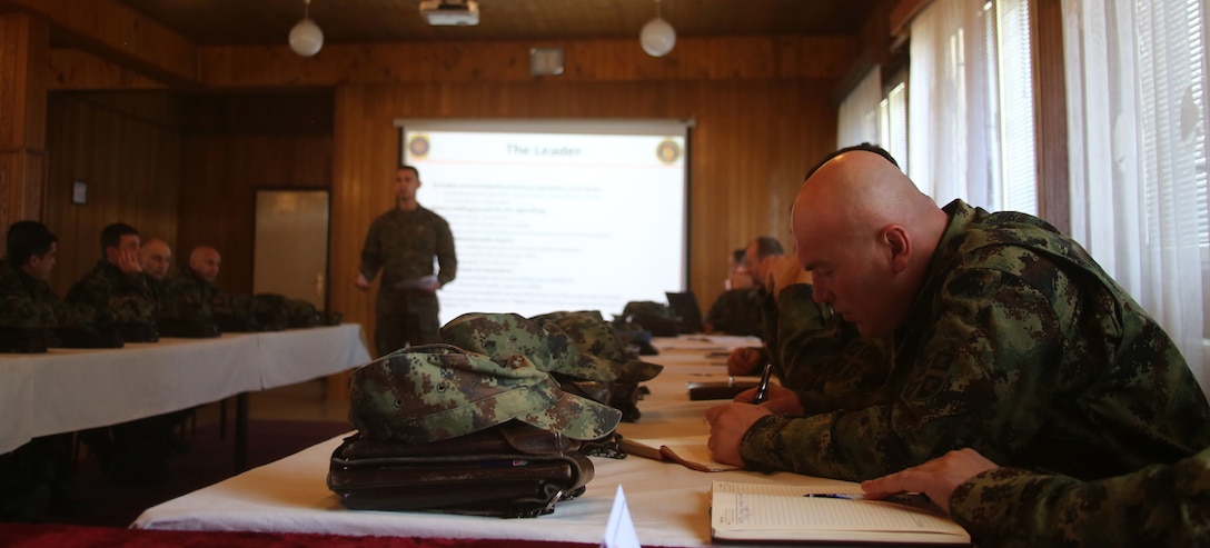 U.S. Marine Corps Staff Sgt. Jonathan Sidhu, with Black Sea Rotational Force supporting the NCO workshop in Serbia, speaks to the group of senior noncommissioned officers at an NCO Workshop at the Serbian Armed Forces Training Center Pancevo, March 3-6, 2015.  Serbian Armed Forces service members engaged with four U.S. Marines in an effort to share information about the noncommissioned officer rank and role and responsibilities of a platoon sergeant. This engagement allowed for a greater understanding in Serbia’s effort in working toward NATO interoperability in the area of leader development. (U.S. Marine Corps photo by 1st Lt. Sarah E. Burns)