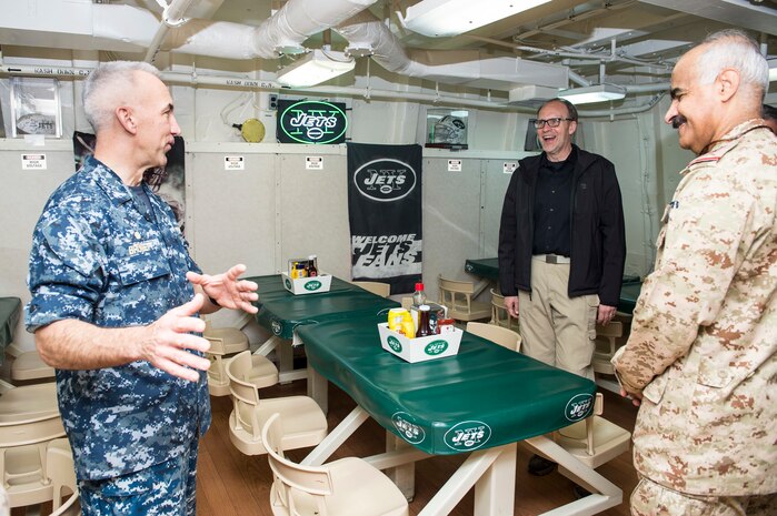 150301-N-XG464-062 -ARABIAN GULF (Mar. 1, 2015) - Capt. Christopher Brunett, left, from Buffalo, N.Y., and commanding officer aboard the amphibious transport dock ship USS New York (LPD 21), presents the Jets room to Douglas Silliman, middle, ambassador to Kuwait, during a distinguished-visitors tour. New York is a part of the Iwo Jima Amphibious Ready Group (ARG) and, with the embarked 24th Marine Expeditionary Unit (MEU), is deployed in support of maritime security operations and theater security cooperation efforts in the U.S. 5th Fleet area of operations. (U.S. Navy photo by Mass Communication Specialist 3rd Class Jonathan B. Trejo/Released)