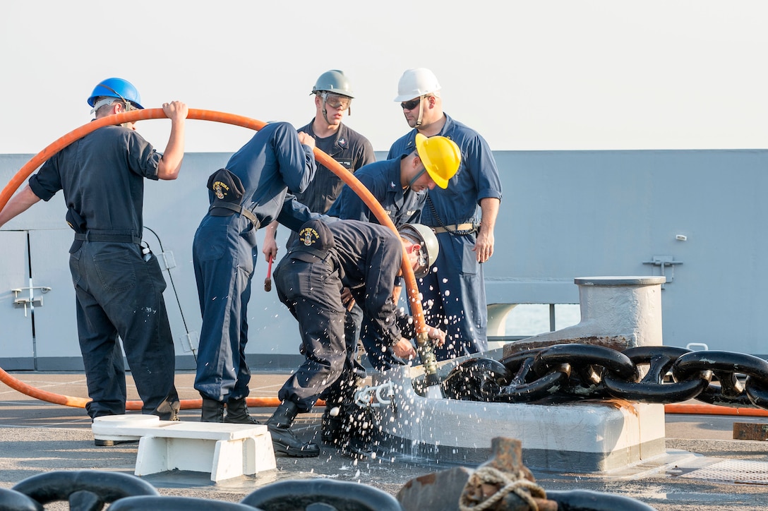 150302-N-XG464-083 -ARABIAN GULF (March 2, 2015) - Sailors clean the anchor chain during an anchoring evolution aboard the amphibious transport dock ship USS New York (LPD 21). New York is a part of the Iwo Jima Amphibious Ready Group (ARG) and, with the embarked 24th Marine Expeditionary Unit (MEU), is deployed in support of maritime security operations and theater security cooperation efforts in the U.S. 5th Fleet area of operations. (U.S. Navy photo by Mass Communication Specialist 3rd Class Jonathan B. Trejo/Released)