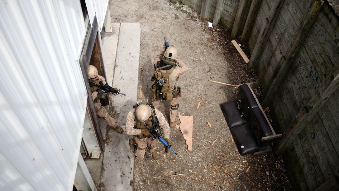 A fire team with 2nd Force Reconnaissance Detachment 6 moves outside after clearing a building during a close-quarters tactics training event at Expeditionary Operations Training Group compound at Stone Bay aboard Marine Corps Base Camp Lejeune, N.C., March 6, 2015.  Marines with 2nd FRD 6 clear and extract unknown targets in a building with narrow hallways and small rooms using tactics and safety standards they learned while at the reconnaissance and surveillance course conducted by EOTG.