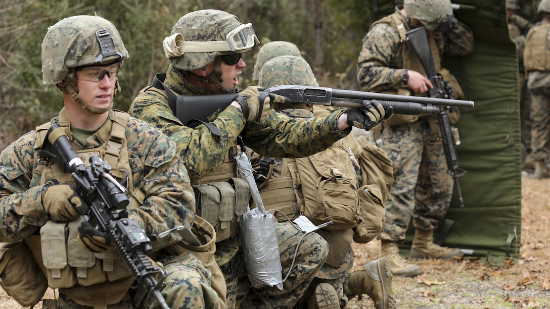 Lance Cpl. Andrew Rogers (left) and Cpl. Dillon F. Lauesen (second from left), both Combat Engineers with Mobility Assault Company, 2nd Combat Engineer Battalion, 2nd Marine Division, provide security for fellow Marines preparing to breach a building during an urban breaching course aboard Camp Lejeune, N.C., March 3, 2015. During this exercise the Marines were reminded to keep situational awareness and to provide security whenever necessary. (U.S. Marine Corps photo by Cpl. Justin T. Updegraff)