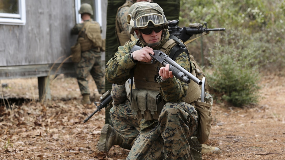 Cpl. Dillon F. Lauesen, a Combat Engineer with Mobility Assault Company, 2nd Combat Engineer Battalion, 2nd Marine Division, provides rear security while a Marine places a window charge at the bottom of a window during an urban breaching course aboard Camp Lejeune, N.C., March 3, 2015. During this exercise the Marines were reminded to keep situational awareness and to provide security whenever necessary. (U.S. Marine Corps photo by Cpl. Justin T. Updegraff)