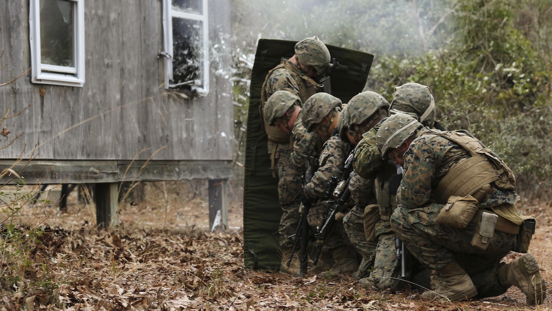 Marines with Mobility Assault Company, 2nd Combat Engineer Battalion, 2nd Marine Division protect themselves from shrapnel produced from the detonation cord aboard Camp Lejeune, N.C., March 3, 2015. For each breach, the Marines would stack up behind a blast blanket, which allows them to stand closer to the blast by protecting them from shrapnel and debris. (U.S. Marine Corps photo by Cpl. Justin T. Updegraff)