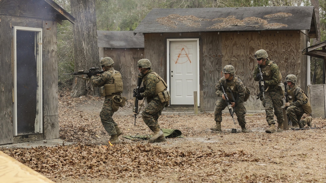 Marines with Mobility Assault Company, 2nd Combat Engineer Battalion, 2nd Marine Division breach and clear a building after blowing the door off its hinges using detonation cord during an urban breaching course aboard Camp Lejeune, N.C., March 3, 2015. The Marines spent the day breaching rooms, sharpening their skills on how to properly prime and detonate detonation cord. (U.S. Marine Corps photo by Cpl. Justin T Updegraff)
