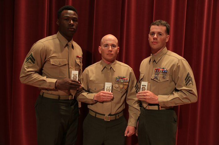 Cpl. Keontaye Dawson, SSgt. Elliott Stanton and Sgt. Tanner Bauer receive gold medals at the awards ceremony of the Competition-In-Arms Program (CIAP) Western Divisional at Marine Corps Base Camp Pendleton, Calif., March 6, 2015.  The Marines, all based at Marine Corps Air Station Yuma, Ariz., have placed in the top ten percent of approximately 240 regional Marine and civilian competitors during the two-week competition.