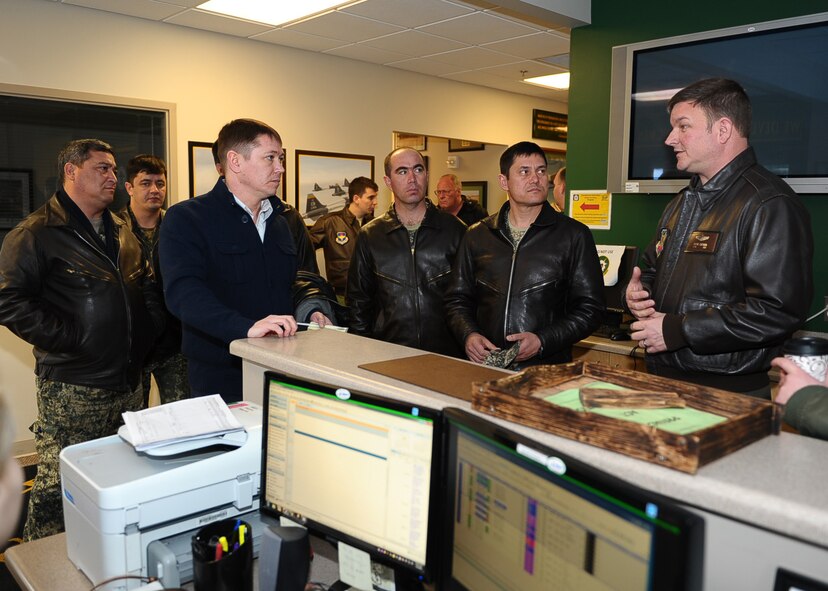 Lt. Col. Wayne Chitmon speaks with Uzbekistan air force members about the 14th Flying Training Wing’s Introduction to Fighter Fundamentals training program March 5, 2015, at Columbus Air Force Base, Miss. The Uzbek troops came here to get a first-hand experience in how they could structure their own pilot training program. Chitmon is the 49th Fighter Training Squadron assistant director of operations. (U.S. Air Force photo/Airman Daniel Lile)