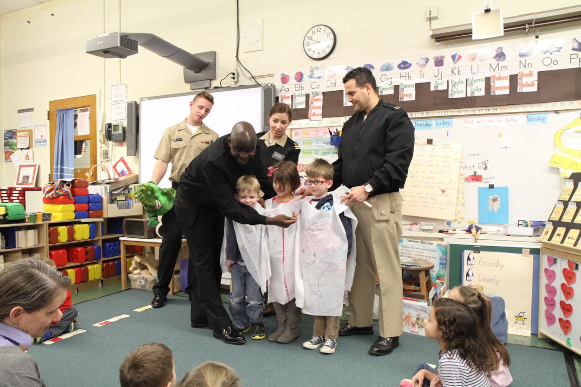 Dentists and hygienists from Naval Health Clinic Quantico, Marine Corps Air Field Annex Dental Clinic, speaks with Students during a recent visit to Russell Elementary School to promote dental hygiene awareness as part of February’s National Children’s Dental Health Awareness Month. 