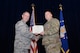 Tech. Sgt. Kristopher K. Parker receives the Purple Heart from Col. Markus Gmehlin, 59th Medical Support Group commander, Feb. 27, 2015 in the Wilford Hall Ambulatory Surgical Center auditorium, Joint Base San Antonio-Lackland, Texas. Parker, a member of the 59th MDW’s Airman Medical Transition Unit, received the distinguished medal for wounds received in action in May 2014 while deployed to Afghanistan. (U.S. Air Force Photo by Staff Sgt. Jason Huddleston)
