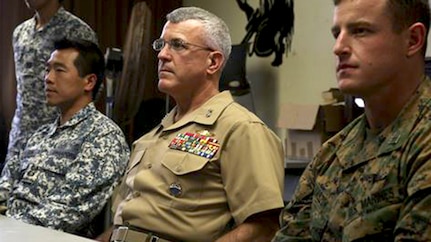In this file photo, (From left to right:) Singaporean Lt. Col. Francis Goh, the commanding officer for the Underwater Demolition Group with Singapore’s Naval Dive Unit; Maj. Gen. James S. Hartsell, the mobilization assistant to the U.S. Pacific Command commander; and Capt. Richard Laszok, the company commander for Bravo Company, 3rd Reconnaissance Battalion, watch as members of the UDG give a presentation over Singapore’s dive tactics Feb. 27, 2015 in one of the School of Infantry-West classrooms in building 223 aboard Marine Corps Base Hawaii. The training was part of Exercise Sandfisher, an annual exercise that provides hands-on experience for Okinawa-based Marines specializing in combatant diving; small-boat operations; underwater navigation; high-altitude, high-opening parachuting and ground reconnaissance tactics. 