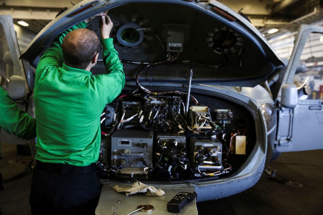 U.S. Navy Seaman Wesley Huddleston does daily maintenance on an MH-60S Seahawk aboard the USS Essex (LHD 2) during Amphibious Squadron/Marine Expeditionary Unit Integration Training (PMINT) off the coast of San Diego March 5, 2015. Huddleston is an aviation electrician’s mate with the Essex Amphibious Ready Group. Sailors and Marines work alongside each other to ensure their gear is well taken care of and ready at a moment’s notice. (U.S. Marine Corps photo by Cpl. Anna Albrecht/ Released)