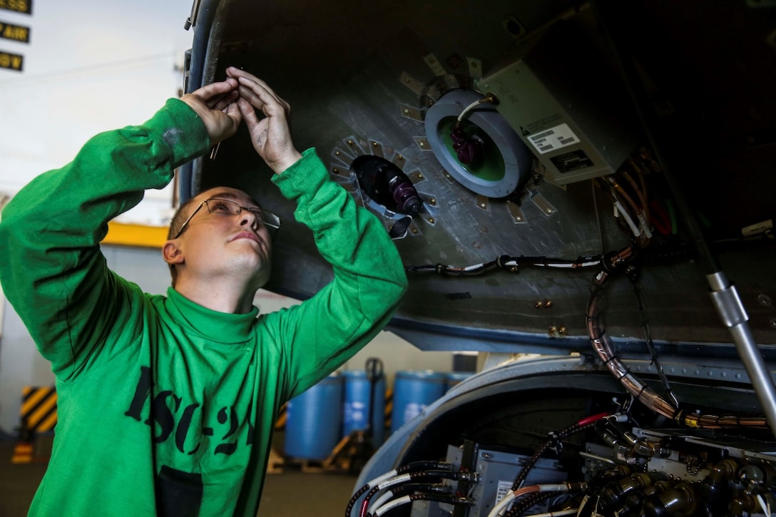 U.S. Navy Seaman Wesley Huddleston does daily maintenance on an MH-60S Seahawk aboard the USS Essex (LHD 2) during Amphibious Squadron/Marine Expeditionary Unit Integration Training (PMINT) off the coast of San Diego March 5, 2015. Huddleston is an aviation electrician’s mate with the Essex Amphibious Ready Group. Marines and Sailors work side-by-side to ensure their aircraft is in the best condition possible. (U.S. Marine Corps photo by Cpl. Anna Albrecht/Released)