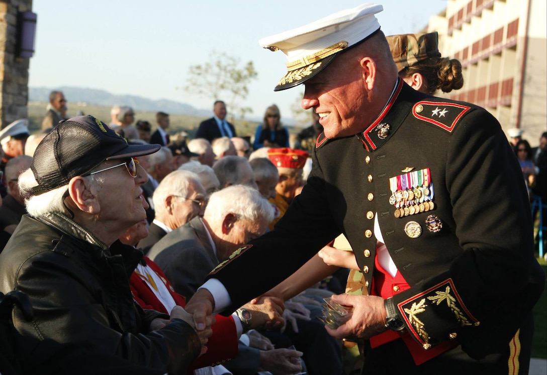Maj. Gen. Lawrence D. Nicholson, Commanding General, 1st Marine Division, shakes hands with World War II veterans during the 70th Anniversary of the Battle of Iwo Jima Commemoration held by Marine Corps Base Camp Pendleton, Marine Corps Installations - West, at the Pacific Views Events Center here, March 7.The event began with a march of the colors, an invocation, and a welcome aboard and guest of honor address. It culminated in a historical reenactment of the flag raising at Mount Suribachi by the Marine Corps Historical Company.